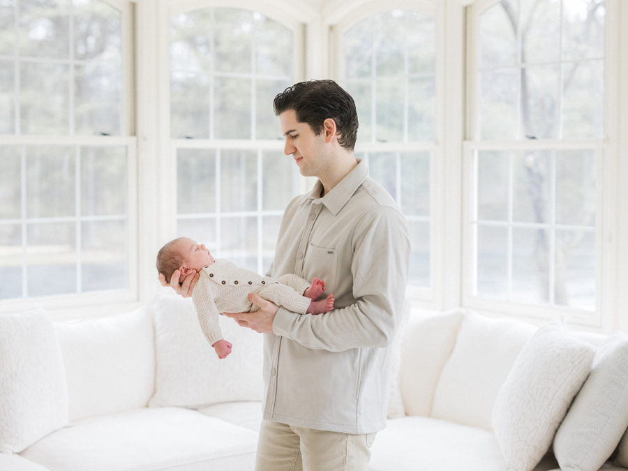 Dad cradles baby Harry in a quiet, intimate newborn portrait by Columbia Missouri Newborn Photographer - Love Tree Studios.