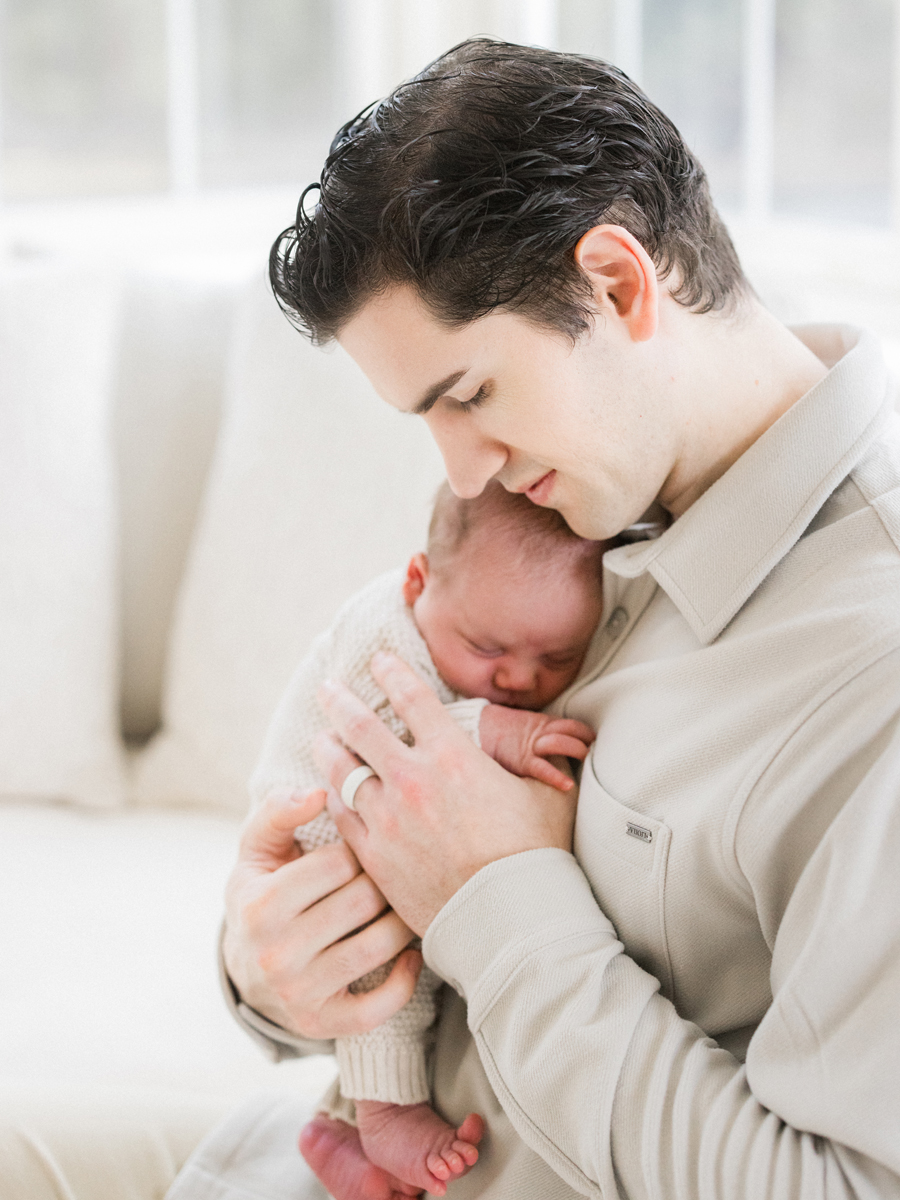 Father and son bonding during a cozy newborn session with Columbia Missouri Newborn Photographer - Love Tree Studios.