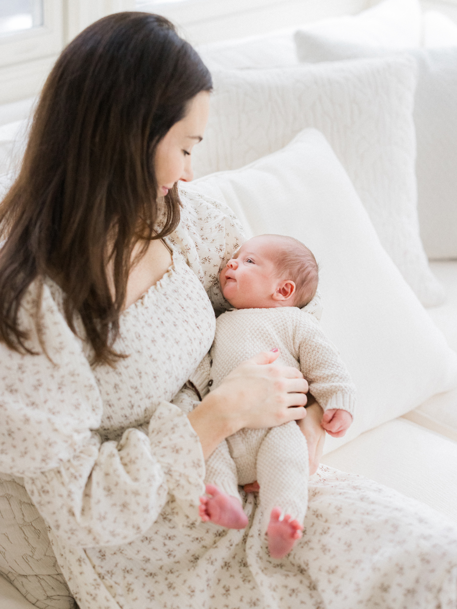 Baby Harry peacefully resting in his mother's arms during a newborn session by Columbia Missouri Newborn Photographer - Love Tree Studios.