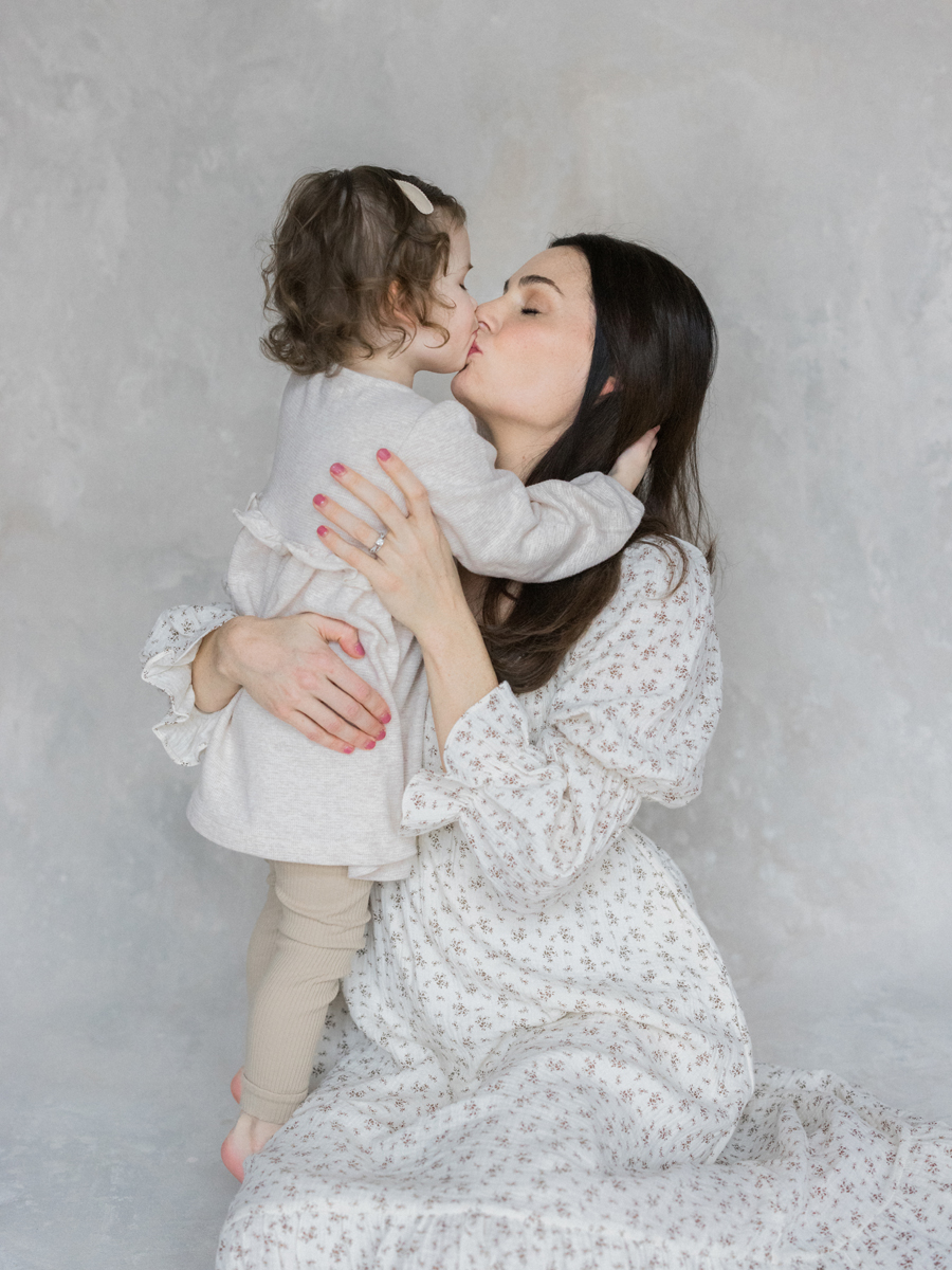 Columbia Missouri Newborn Photographer captures Millie snuggling close to her mom in a warm and intimate family moment - Love Tree Studios.