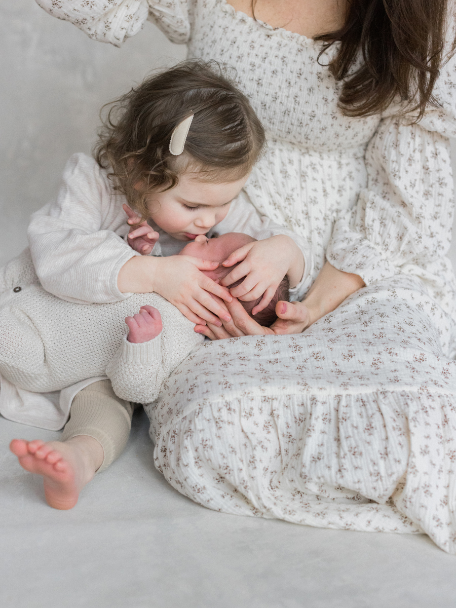 Sibling love shines in this newborn photography session in Columbia Missouri by Love Tree Studios.