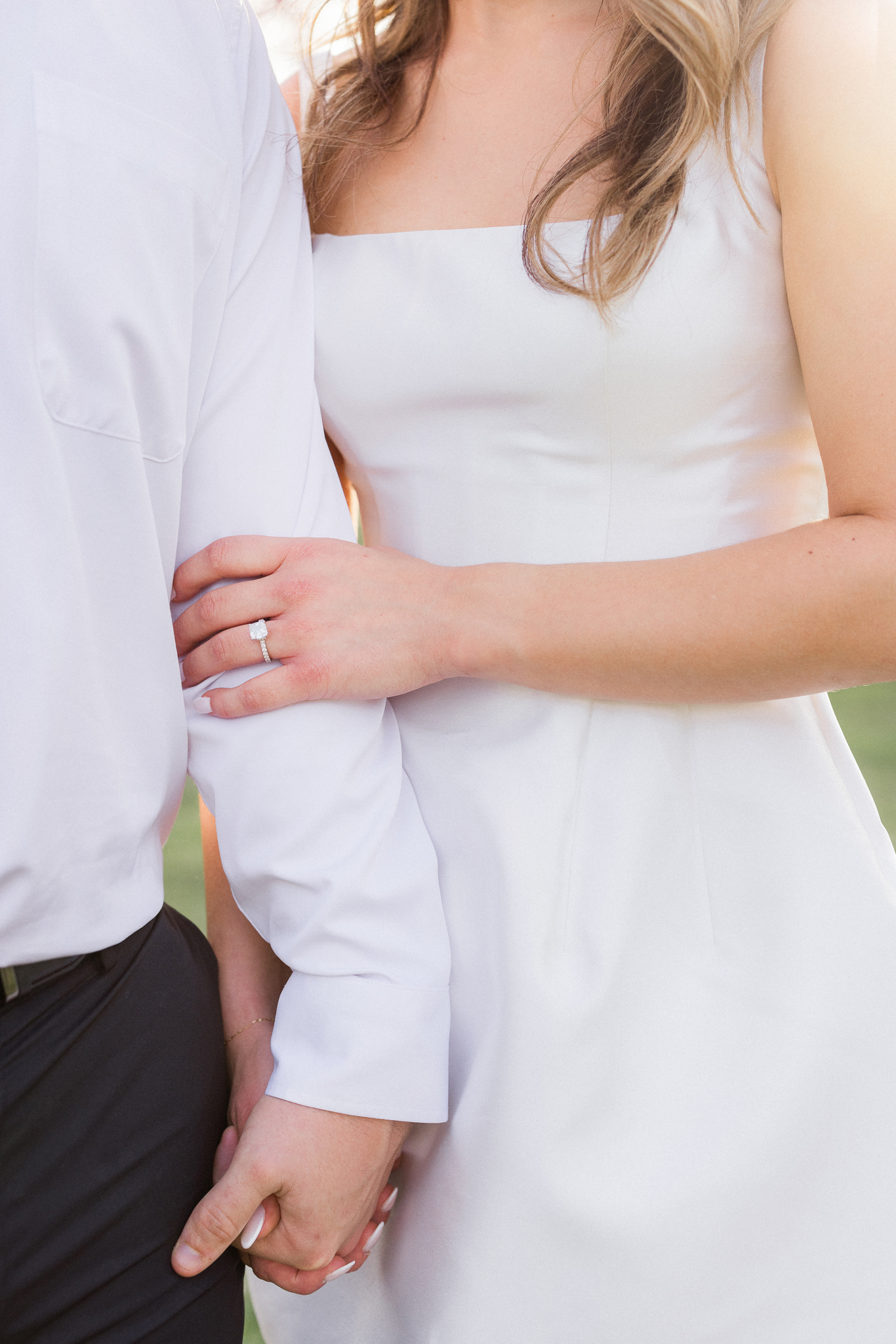 Close up of the couple holding hands during their romantic spring engagement session in Missouri.
