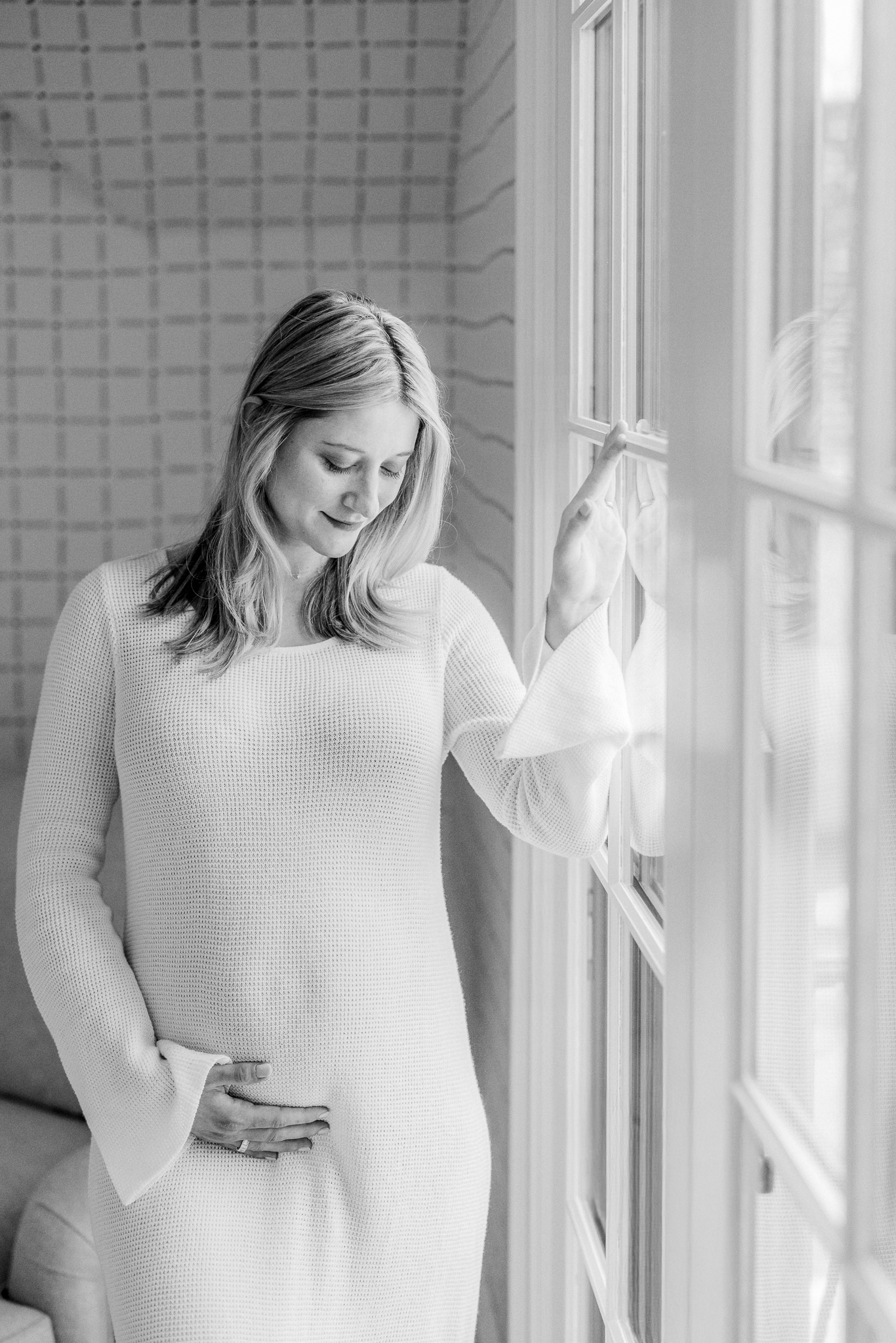 Natural light maternity portrait of pregnant mother smiling softly during Columbia MO photo session.