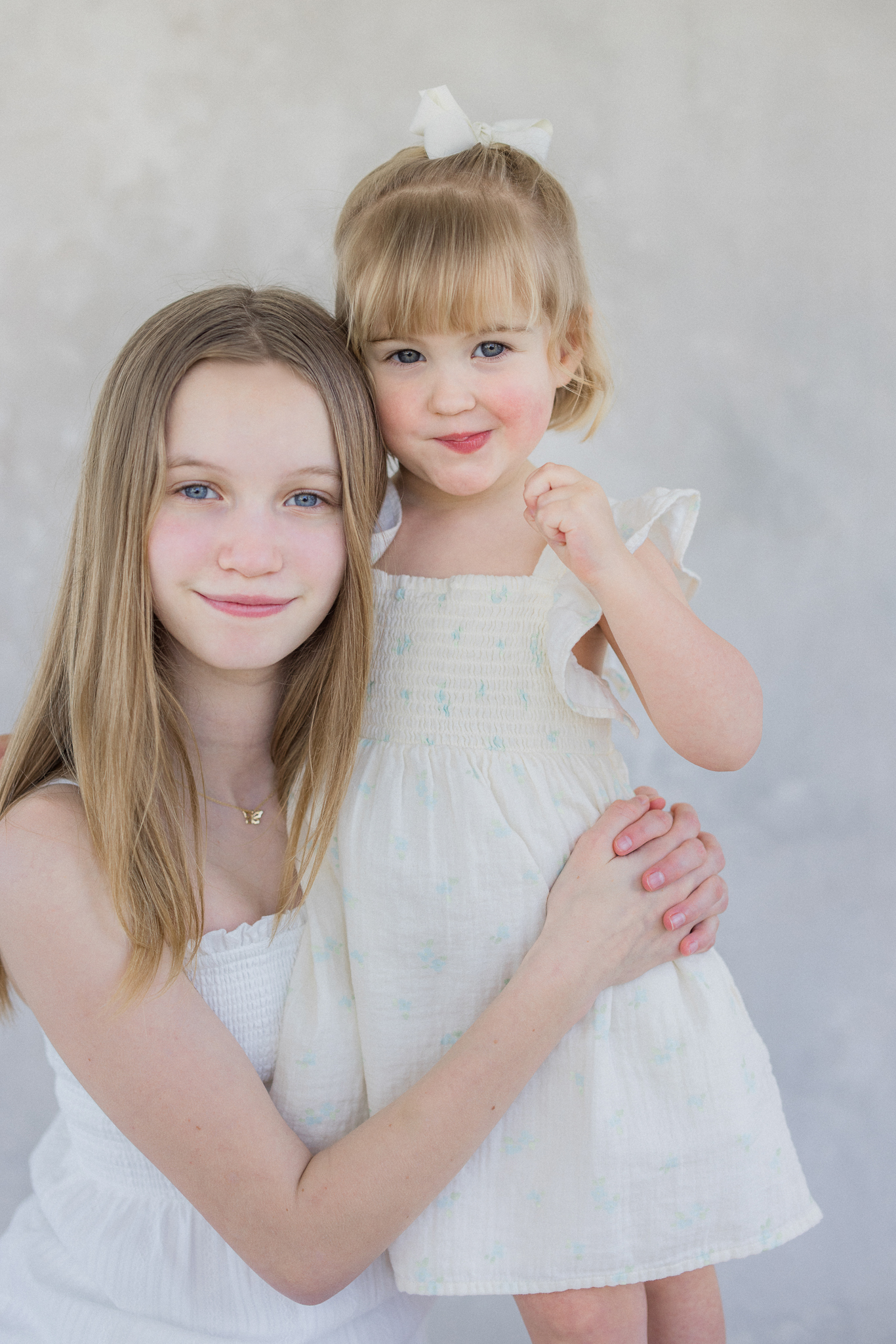 Rosie looking up at the camera with wide blue eyes and rosy cheeks — Missouri motherhood photography by Love Tree Studios.