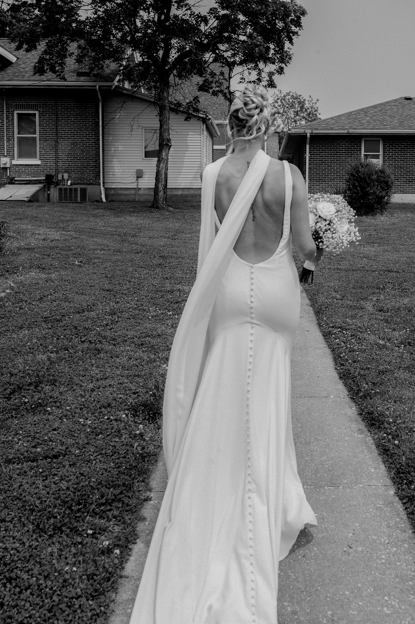 Bride walking alone in her wedding gown toward the church captured by Love Tree Studios for Jefferson City wedding photography in Jefferson City, Missouri.