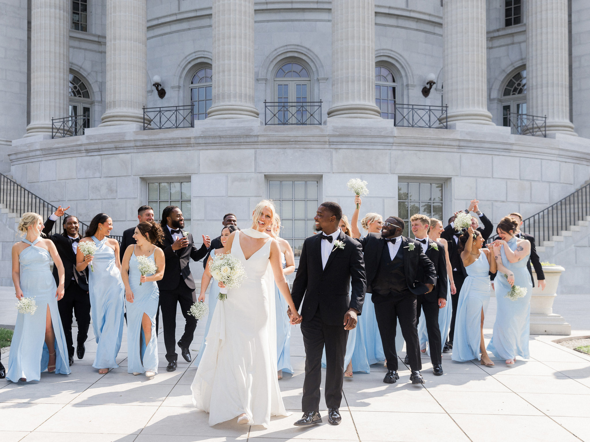 Wedding party walking outside The Capitol in Jefferson City captured by Love Tree Studios for Jefferson City wedding photography in Jefferson City, Missouri.

