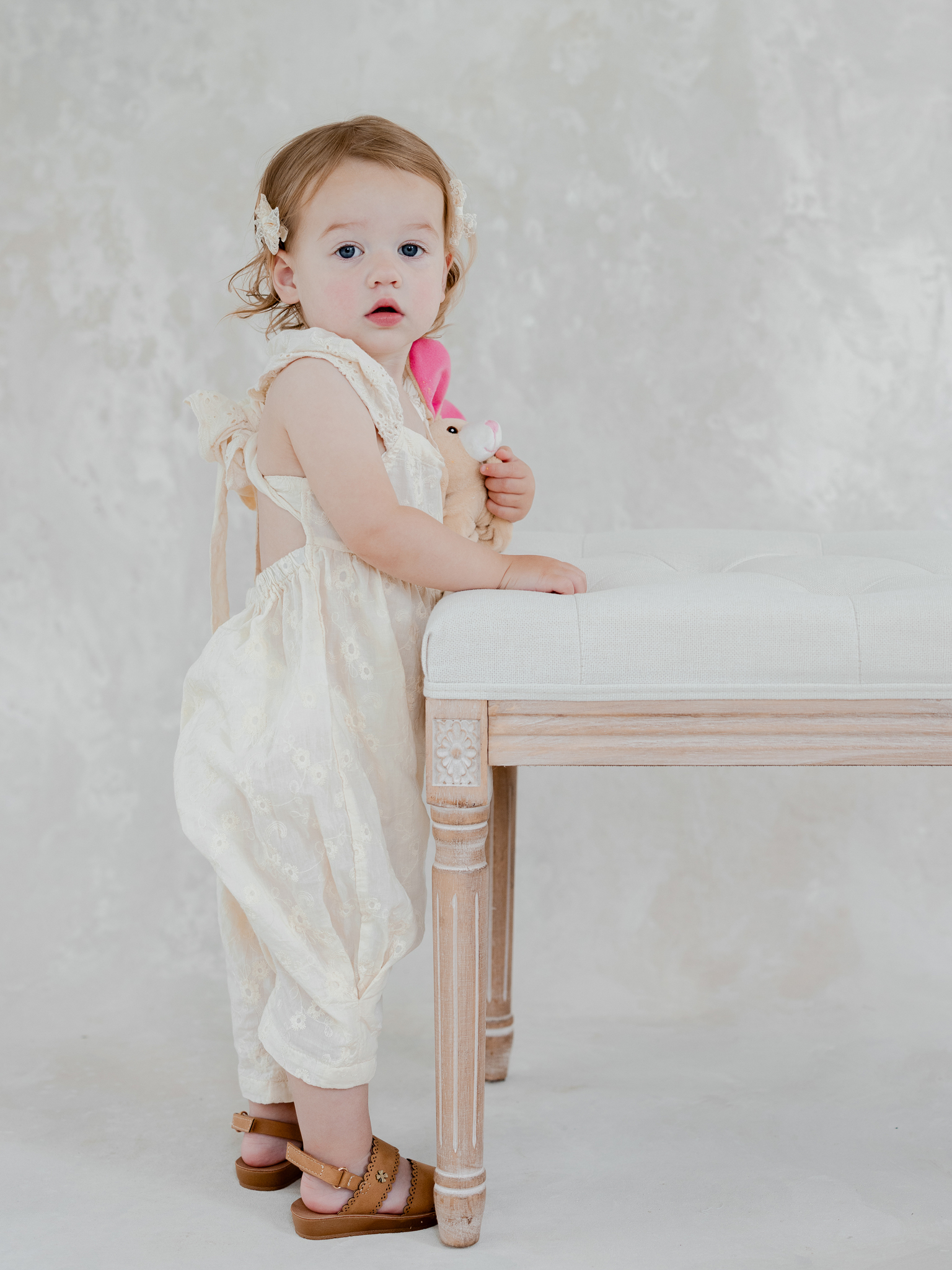 Studio portrait of Parker holding her stuffed bunny during her family photo session at Love Tree Studios in Columbia, Missouri.