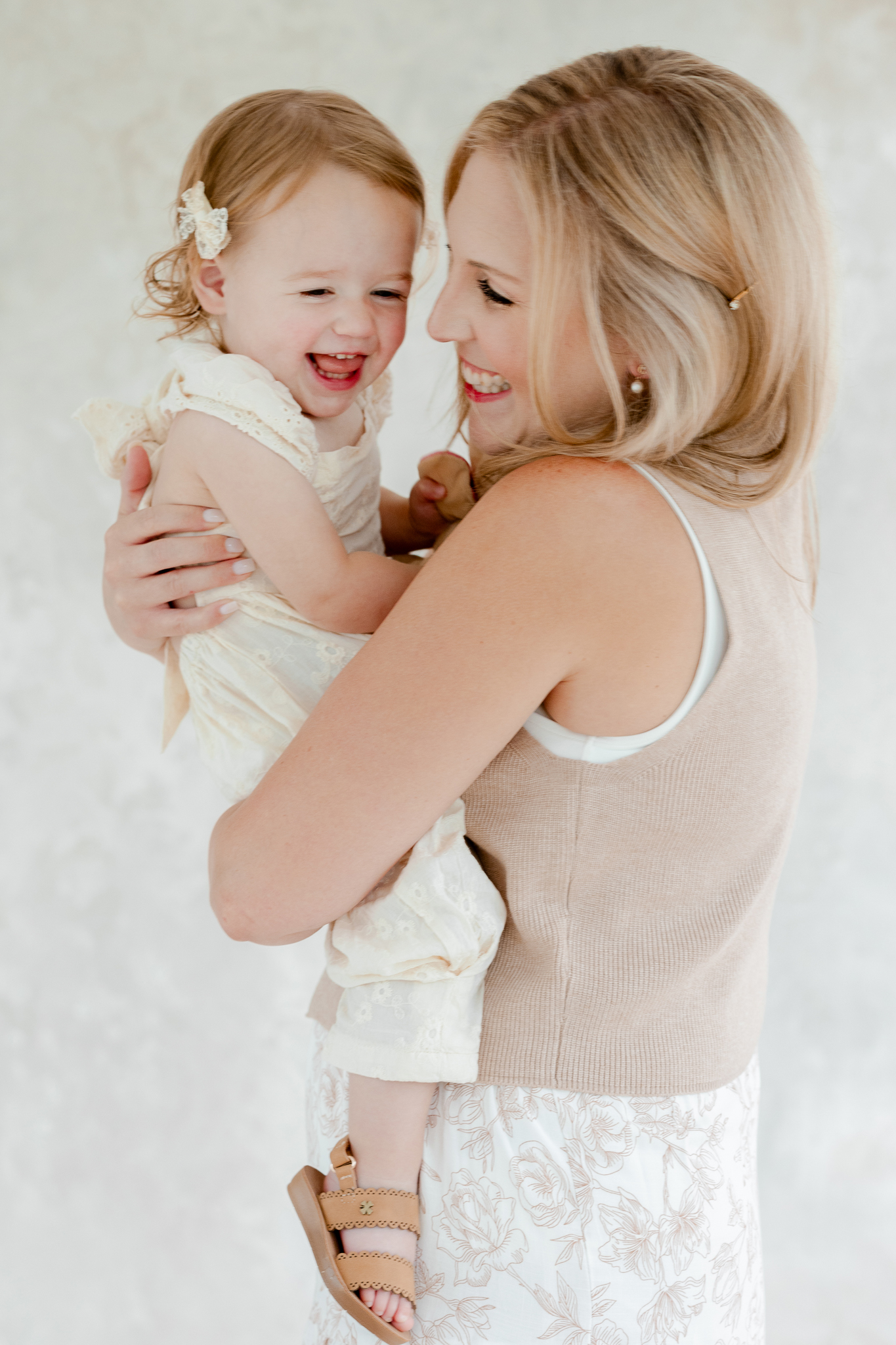 Joyful laughter between mom and daughter during a studio family photo session in Columbia, Missouri with Love Tree Studios.