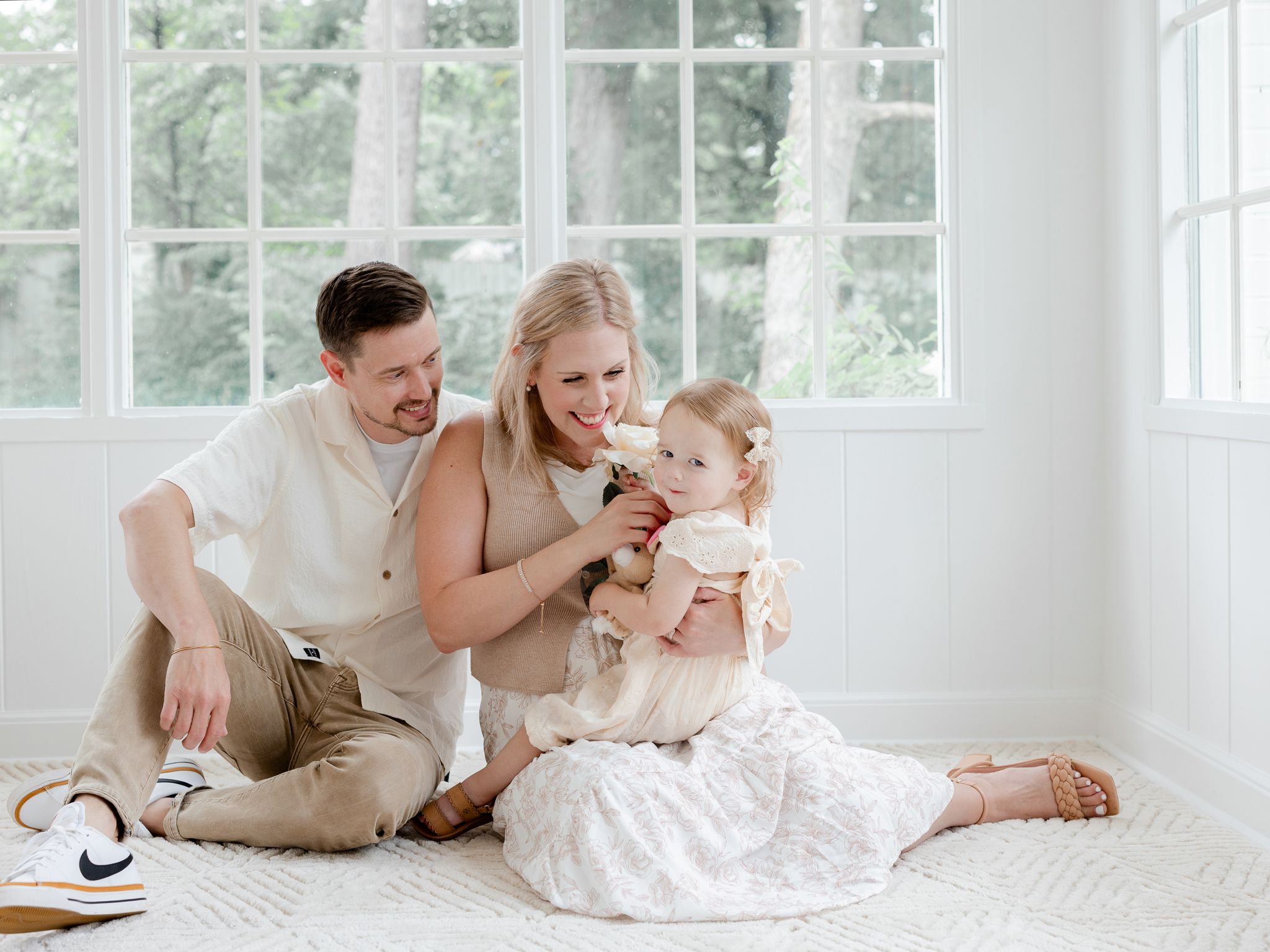 The Bradley family cuddling together during their light-filled studio family session with Love Tree Studios in Columbia, Missouri.