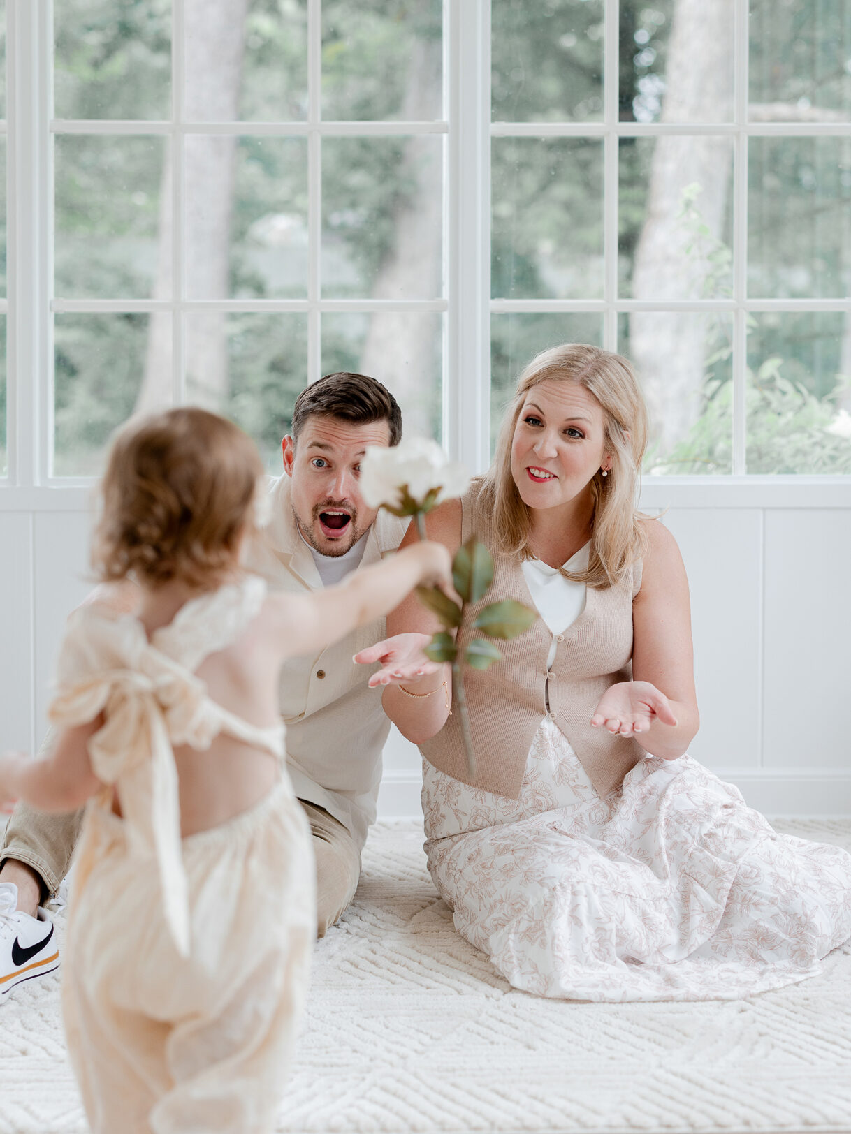 Candid moment of Parker bringing a flower to her parents during their Love Tree Studios session in Columbia, Missouri.