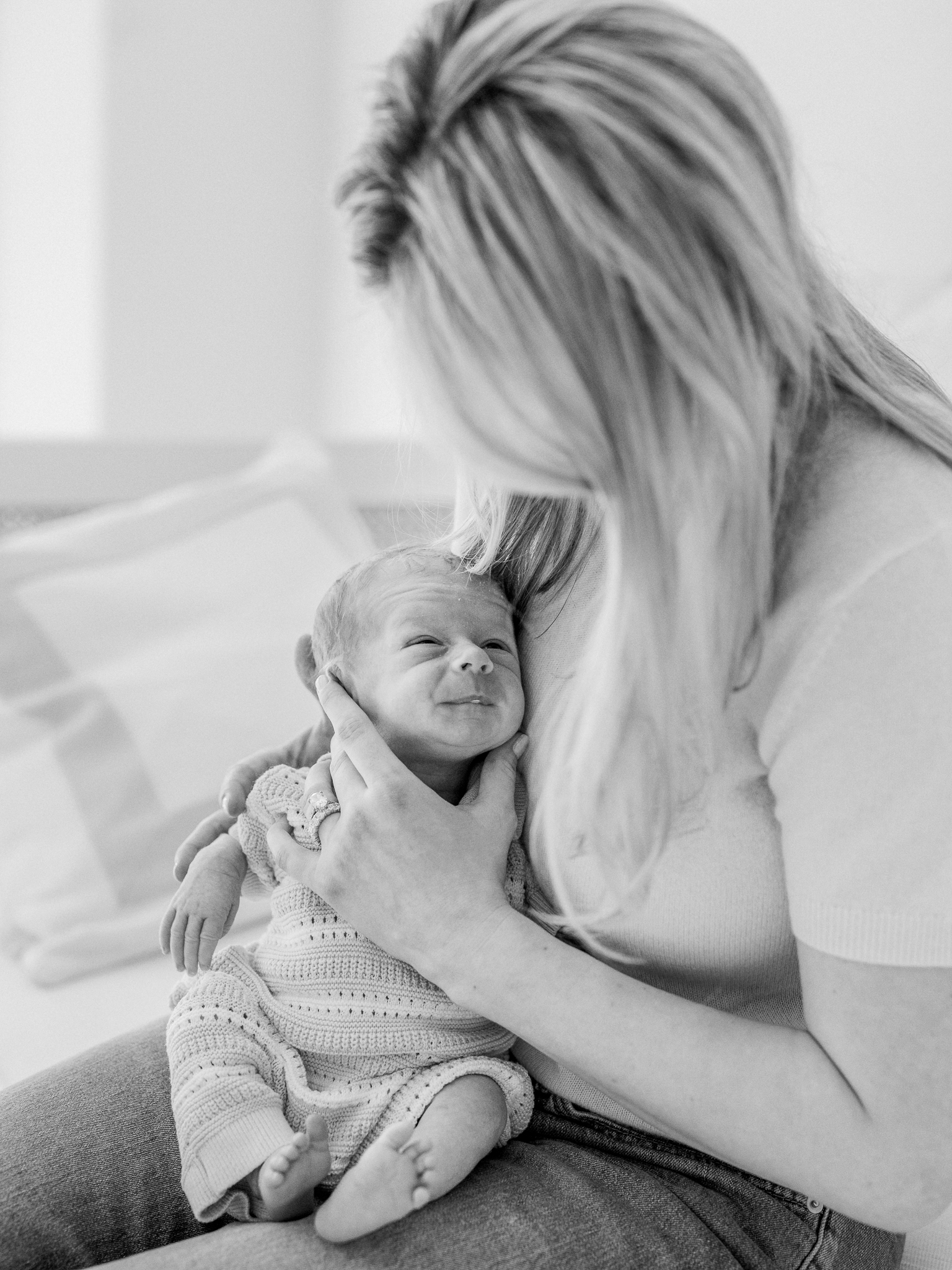 Tender black and white moment of mom holding baby on her shoulder during a Columbia Missouri newborn session.