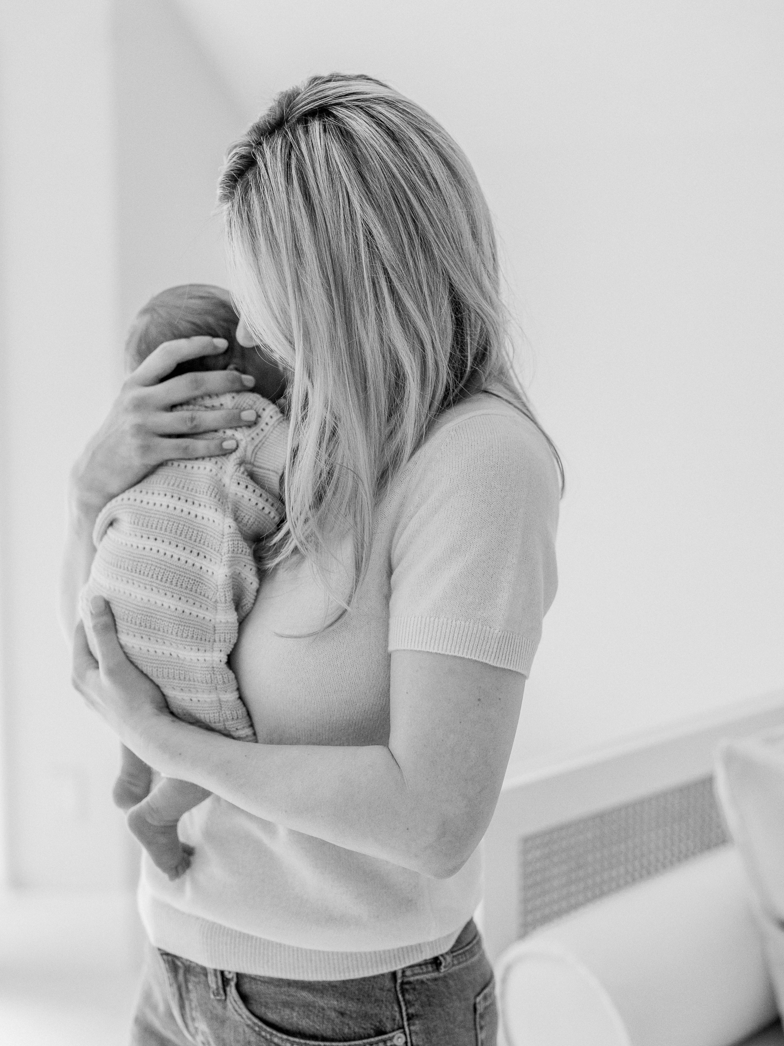 Black and white image of mom cradling newborn during their Columbia Missouri newborn session.