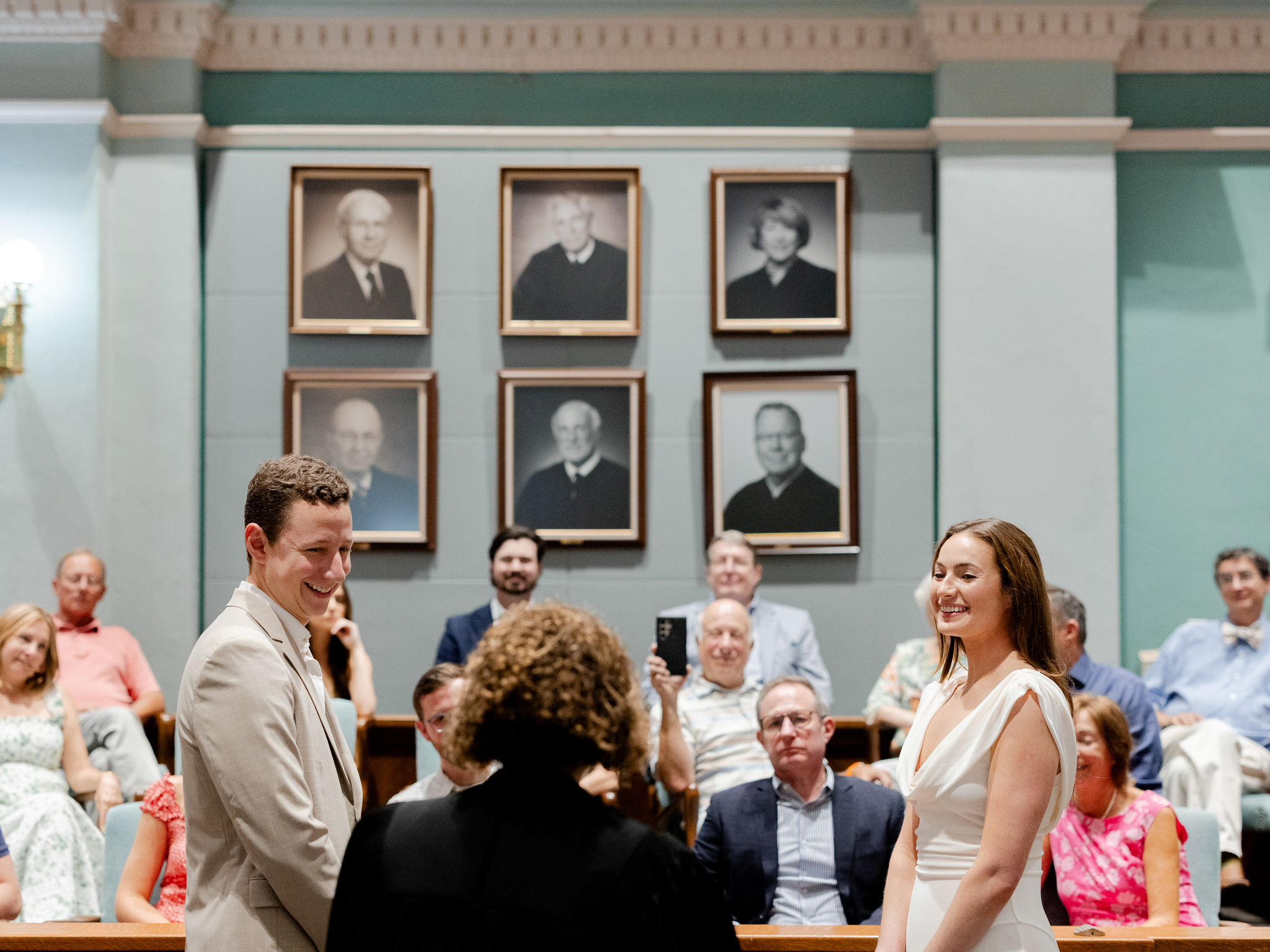 Color image of Arthur smiling at Madison during their wedding ceremony in the Boone County Courthouse – courthouse wedding in Columbia Missouri by Love Tree Studios.