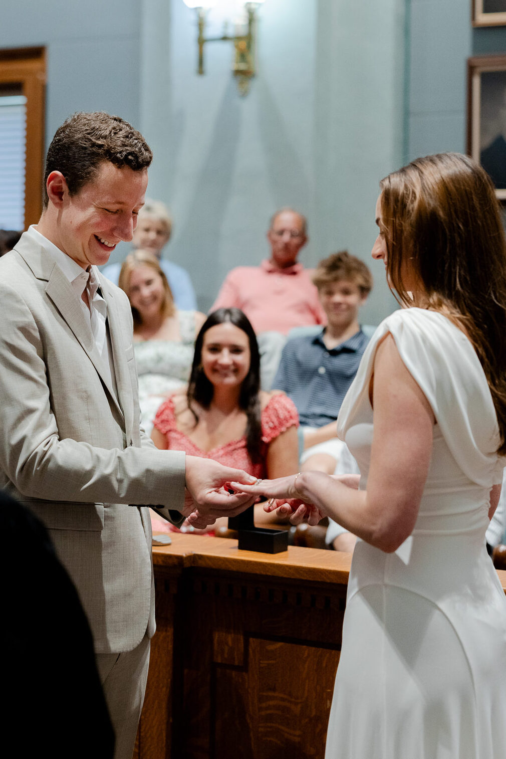 Arthur placing the wedding ring on Madison’s finger during their courthouse wedding in Columbia Missouri, photographed by Love Tree Studios.