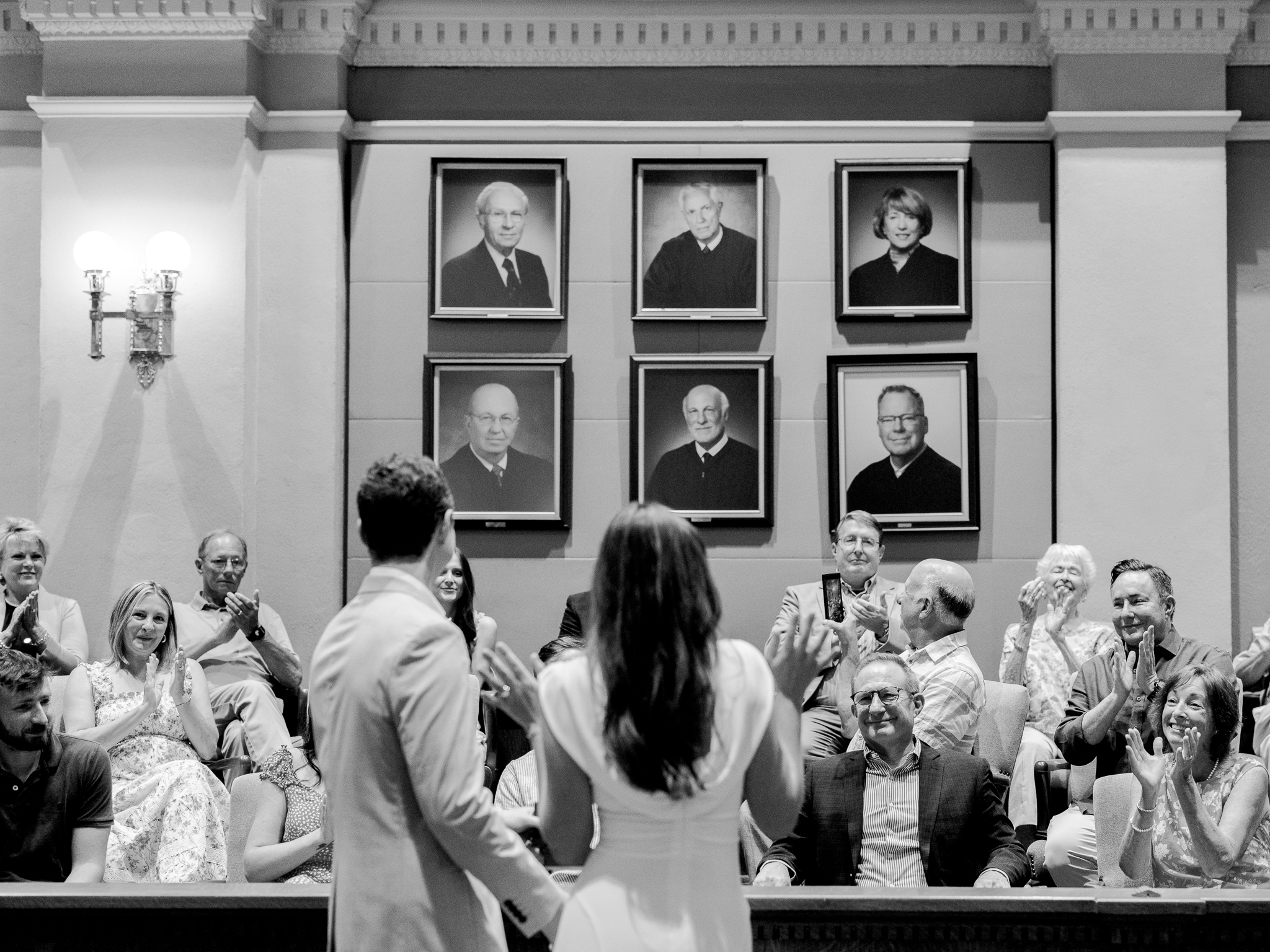 Guests applauding as Arthur and Madison are pronounced married during their courthouse wedding in Columbia Missouri – image by Love Tree Studios.