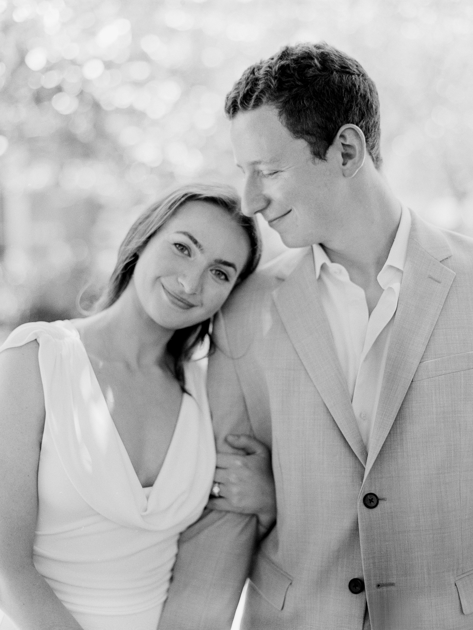 Black and white film portrait of Madison resting her head on Arthur’s shoulder – courthouse wedding in Columbia Missouri by Love Tree Studios.