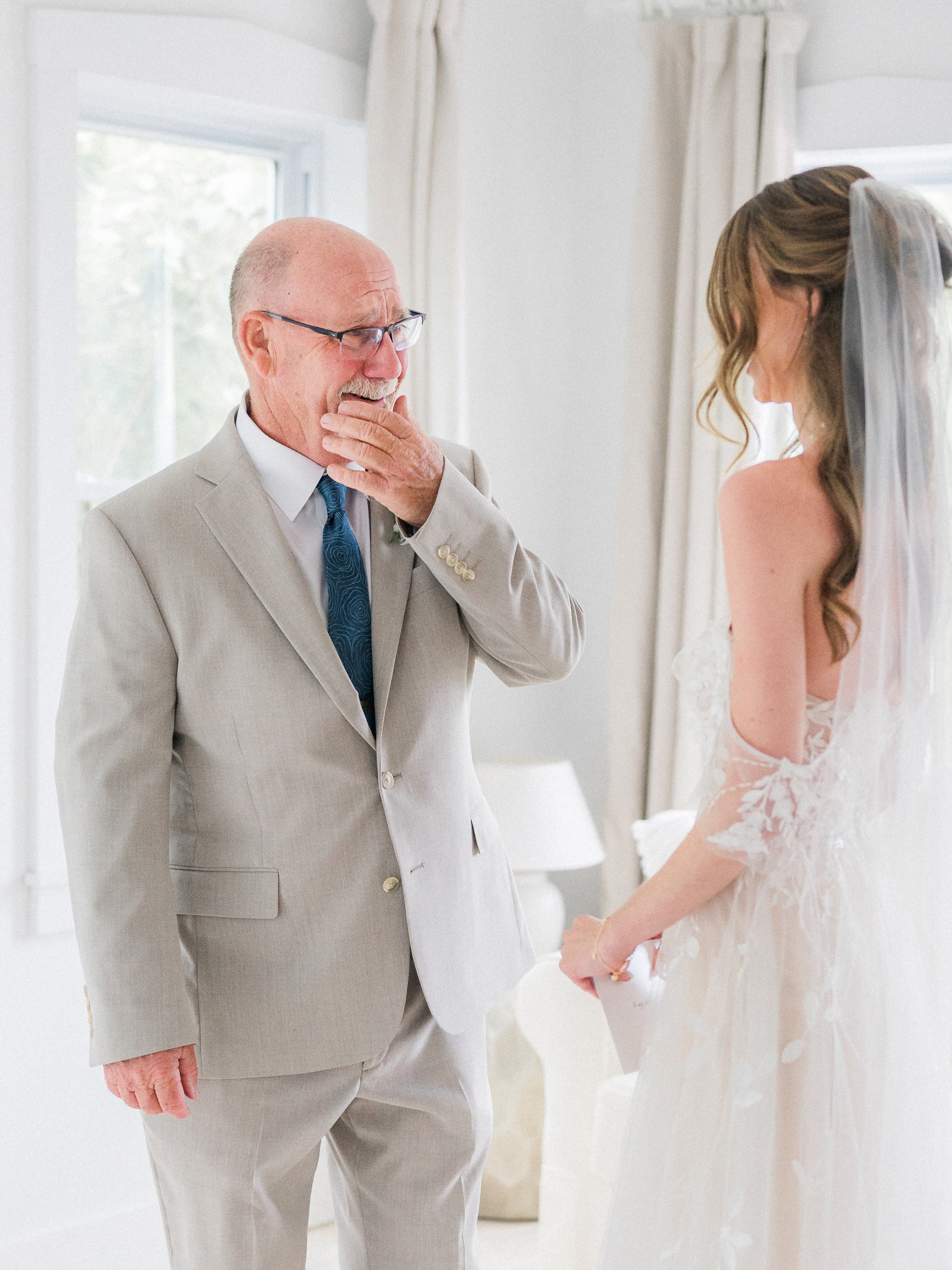 Father of the bride gets emotional seeing his daughter in her wedding dress for the first time.