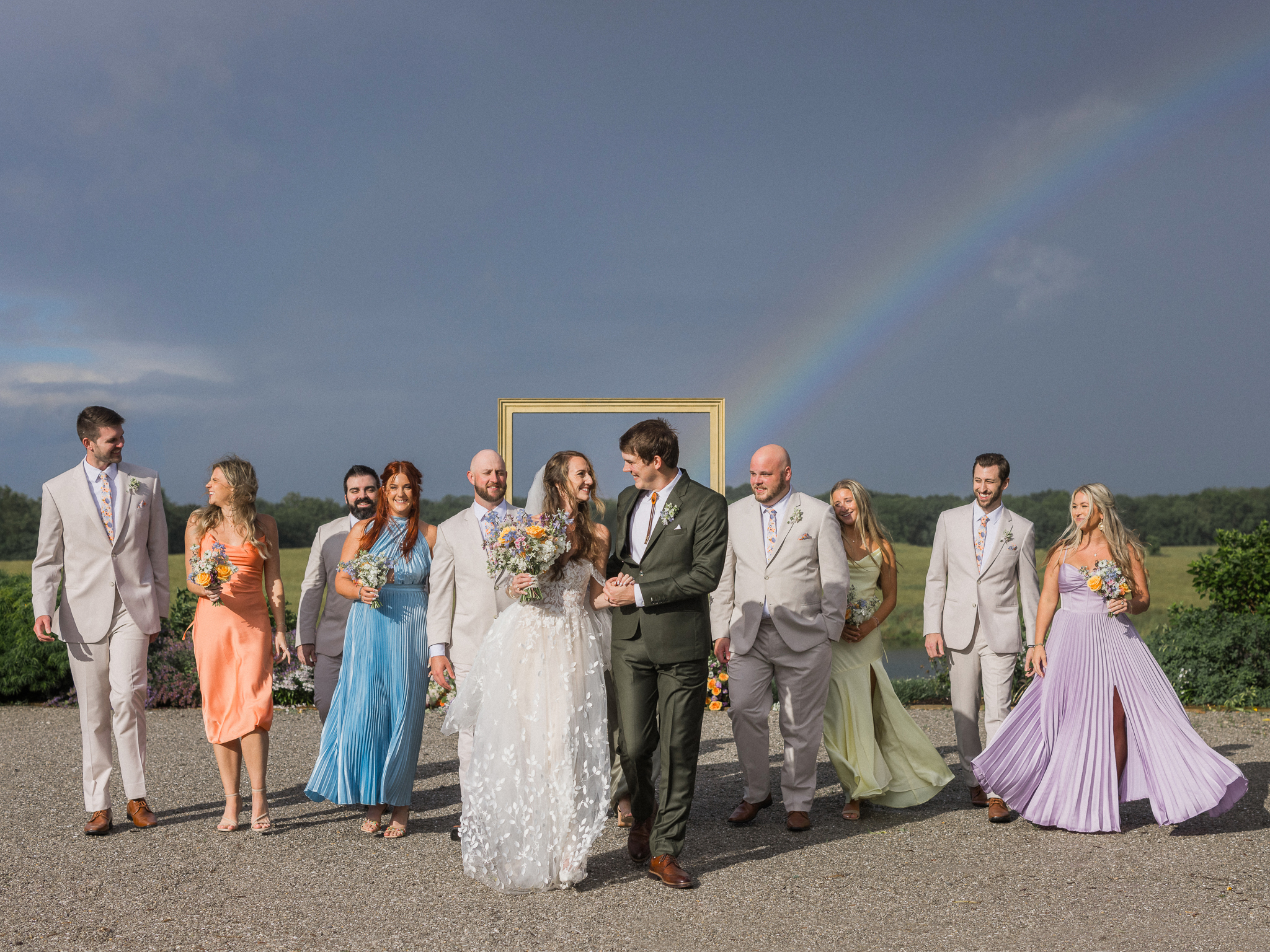 The whole wedding party shares a joyful walk under the rainbow at this unforgettable Blue Bell Farm wedding.