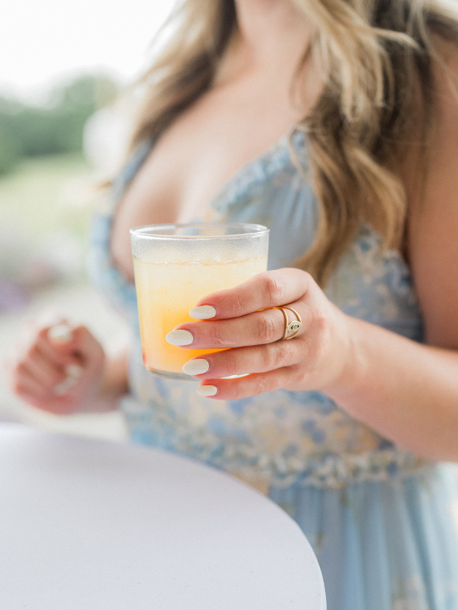 Signature cocktail in hand, guests toasted under the twinkle lights at this dreamy Blue Bell Farm wedding.