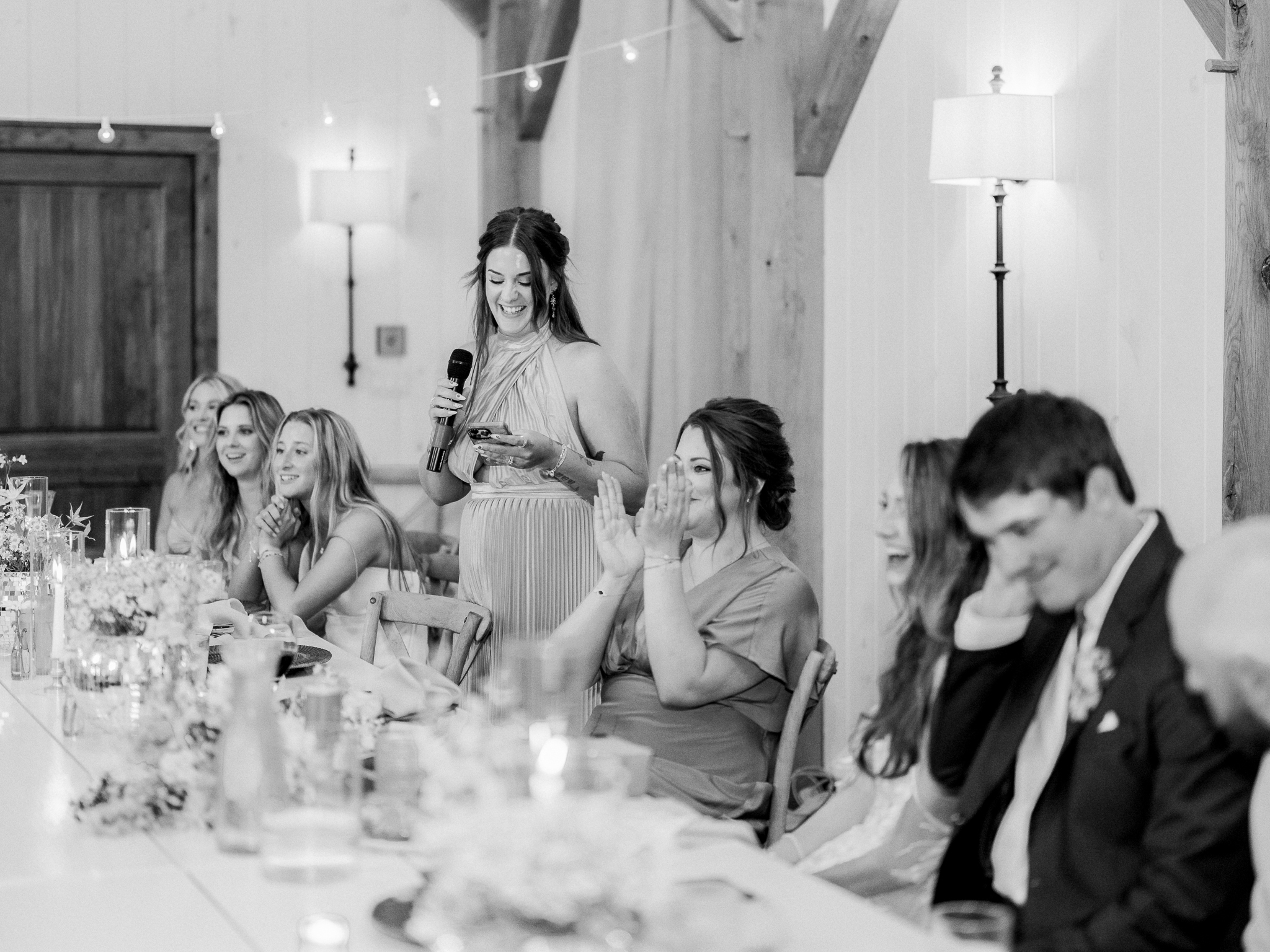 Friends and family enjoy stories and laughter at Jenny and Cooper’s Blue Bell Farm wedding reception.