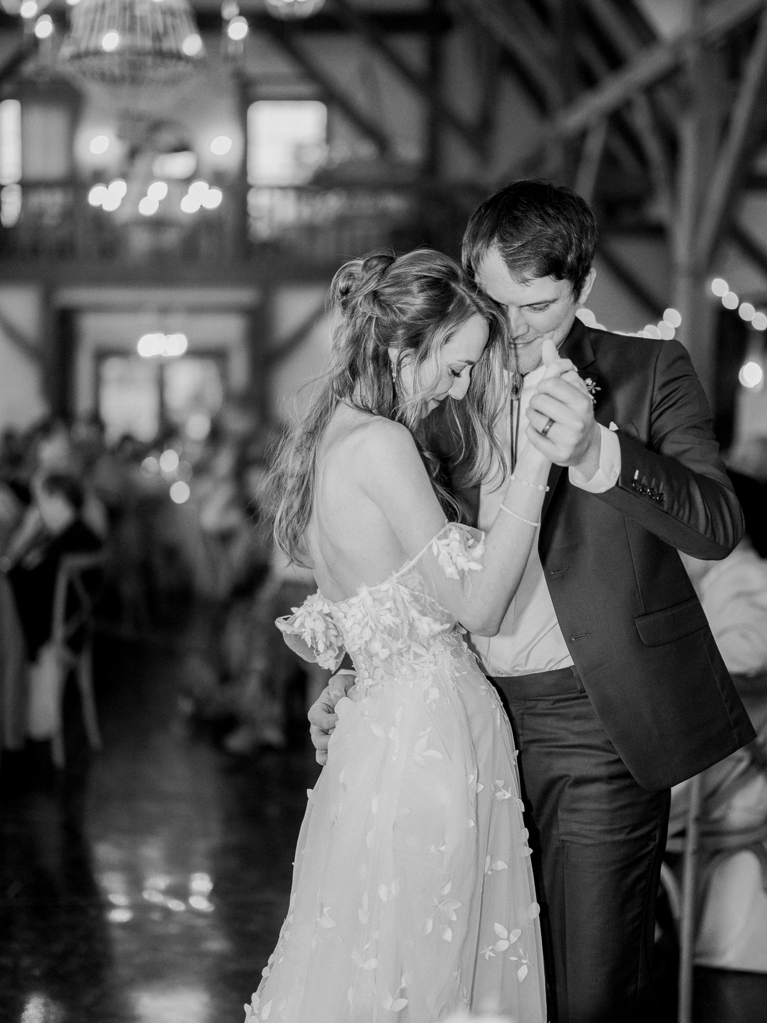 Jenny and Cooper dance close, surrounded by love and candlelight at their Blue Bell Farm wedding.