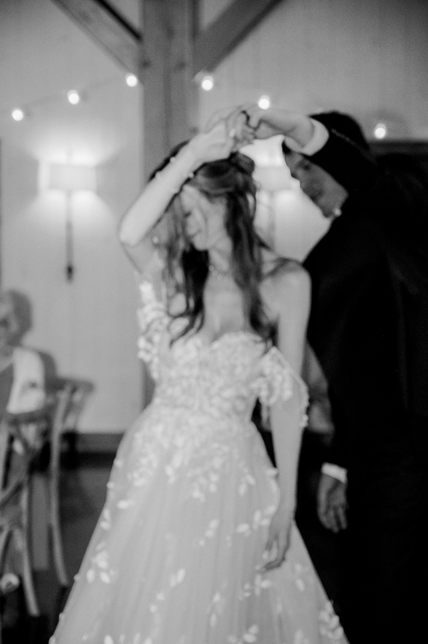 A joyful spin under twinkling lights makes for a magical moment at this Blue Bell Farm wedding.