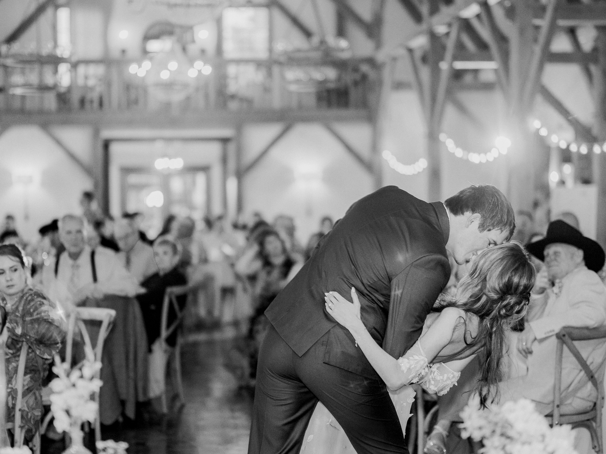 A romantic dip and kiss wow the crowd during Jenny and Cooper’s Blue Bell Farm wedding celebration.