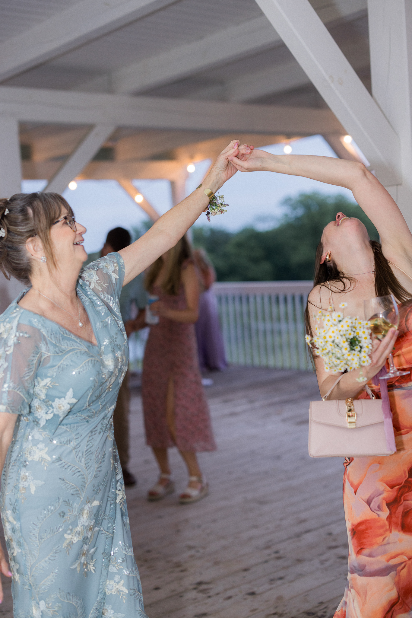 Jenny shares a joyful dance with her mom and loved ones at her Blue Bell Farm wedding.