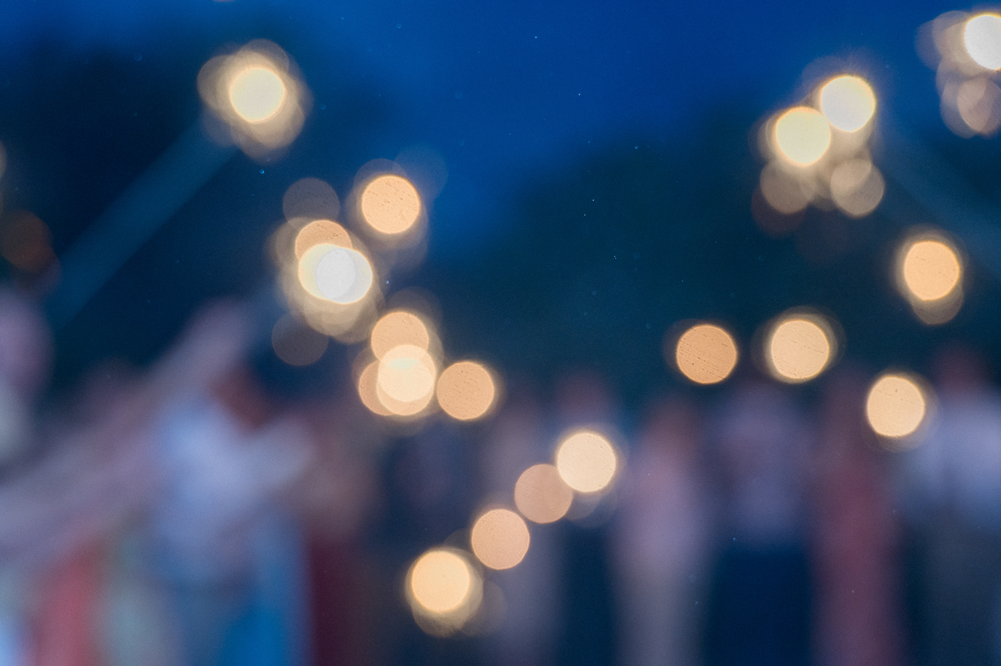 An artistic bokeh shot of sparklers glowing against the night sky during the send-off at a Blue Bell Farm wedding, photographed by Love Tree Studios.
