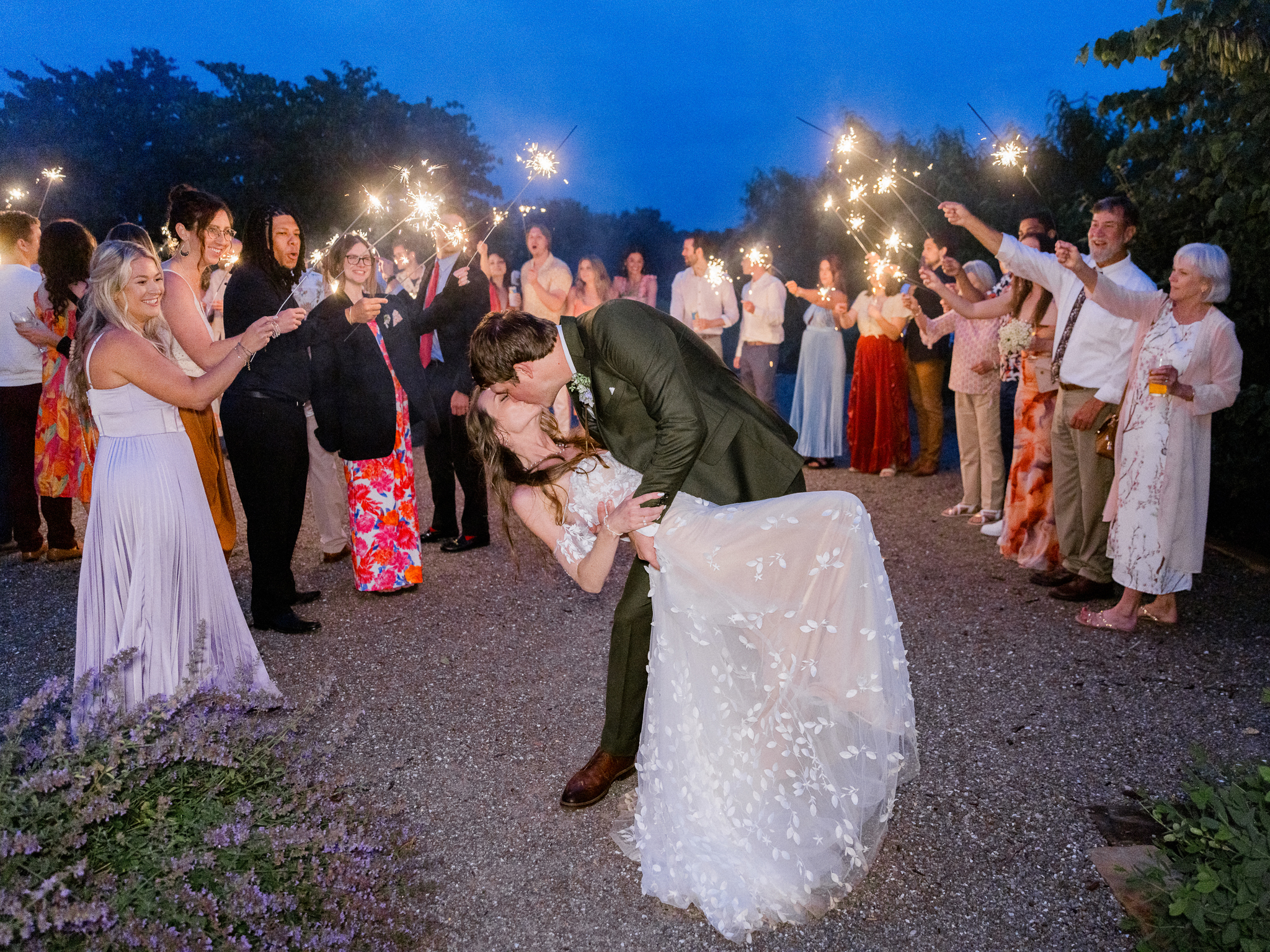 Guests gather around with sparklers in hand during the Blue Bell Farm wedding sparkler send-off, photographed by Love Tree Studios.