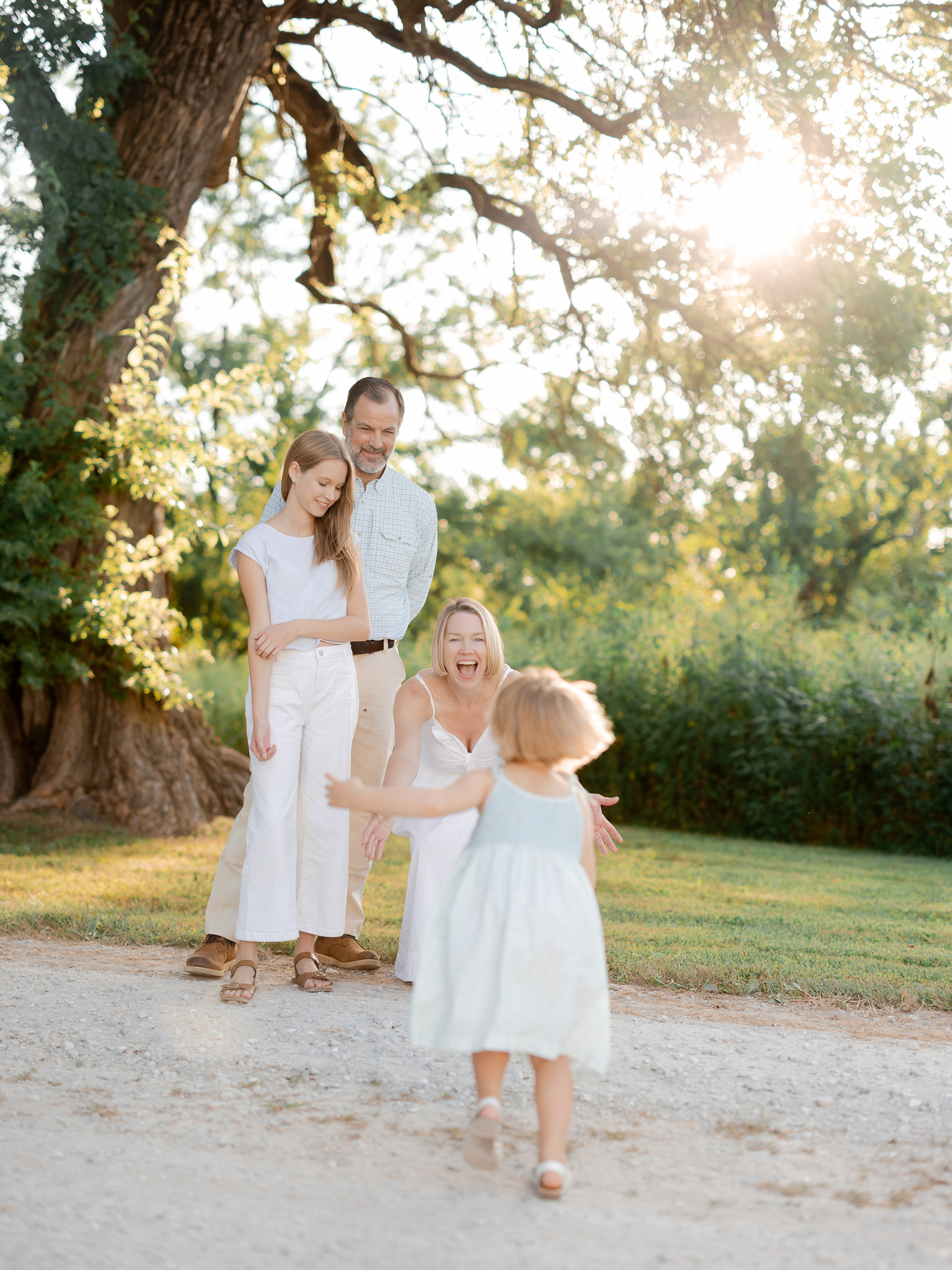 Toddler running into her mother’s arms during a Missouri family photography session.