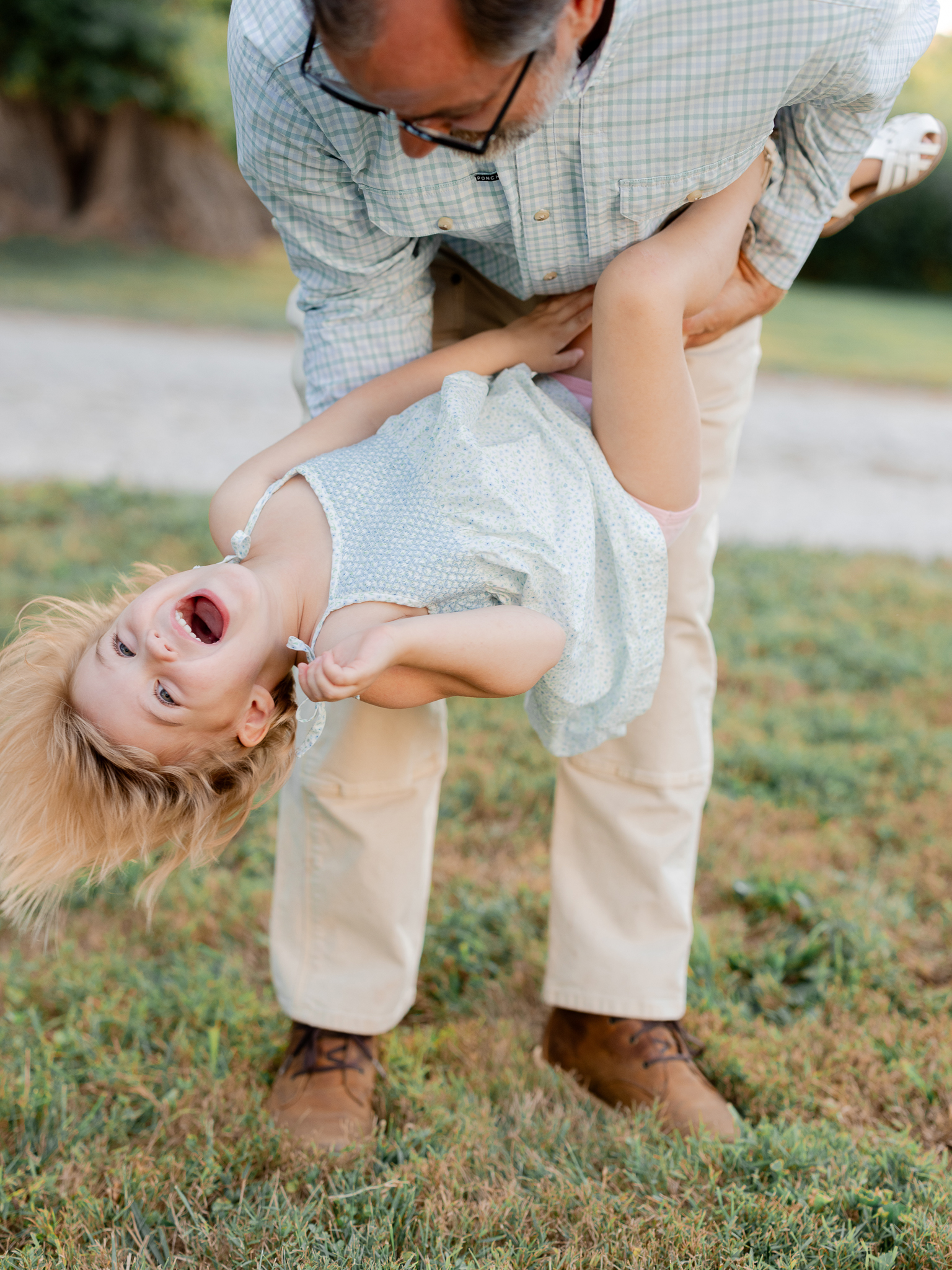 Father playing with daughter upside down — Love Tree Studios family photography in Missouri.