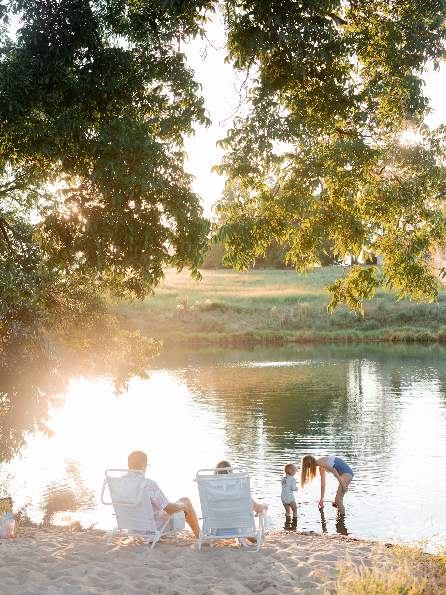 Family relaxing at their lake beach — Missouri family photographer Love Tree Studios.