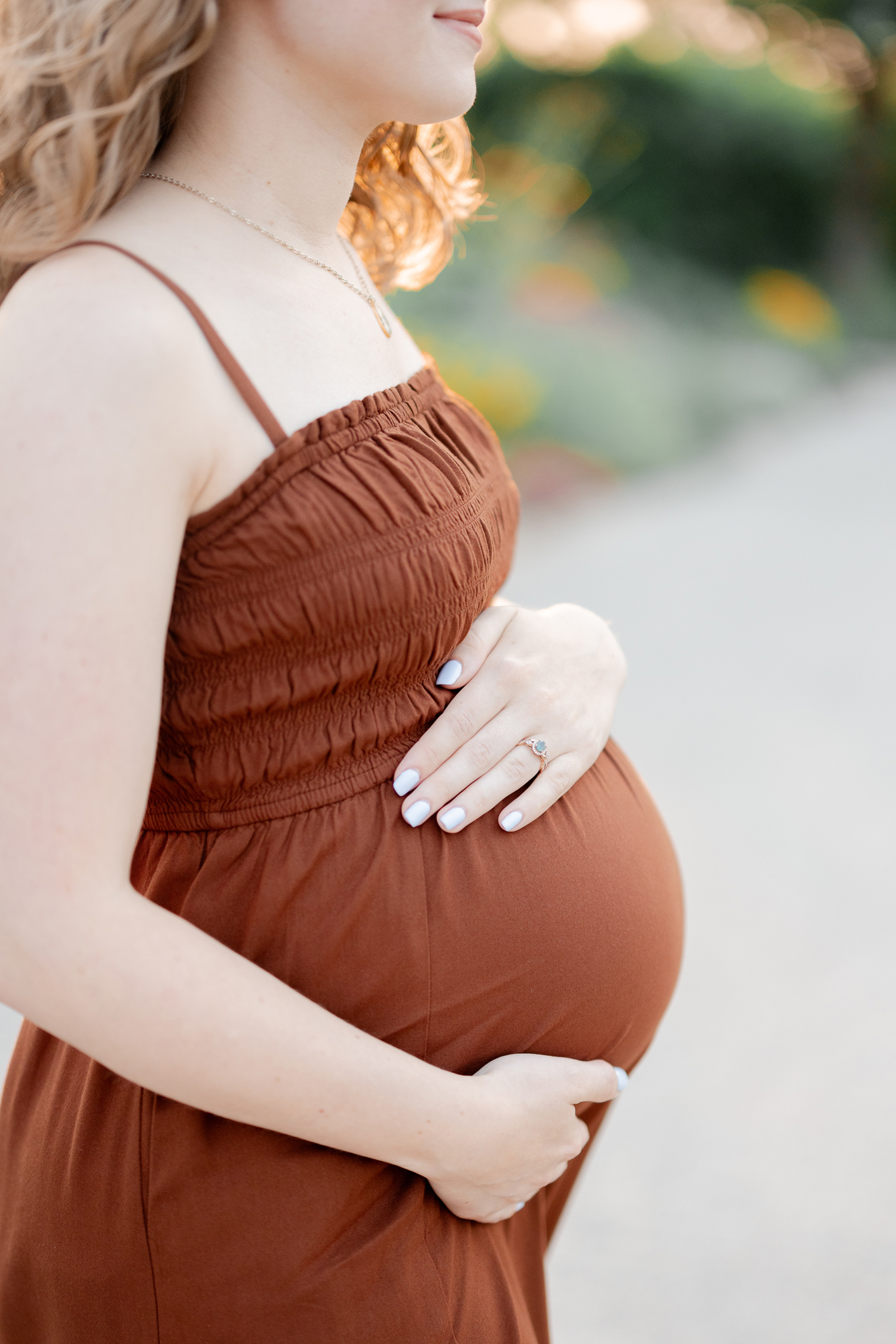 A joyful maternity walk hand in hand on Art Hill in St. Louis, photographed by Love Tree Studios maternity photographer.