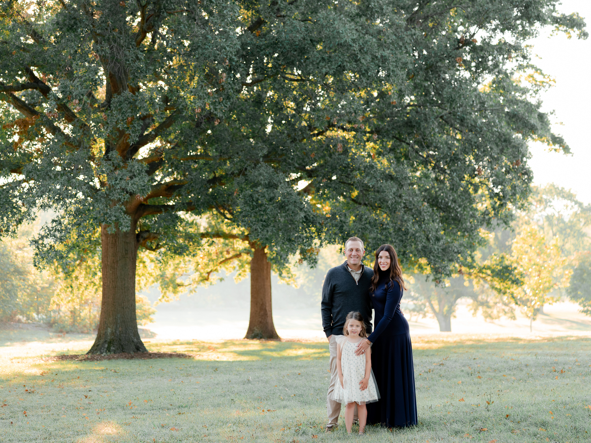 Family standing together under oak trees at sunrise – sunrise family photos Columbia Missouri by Love Tree Studios.