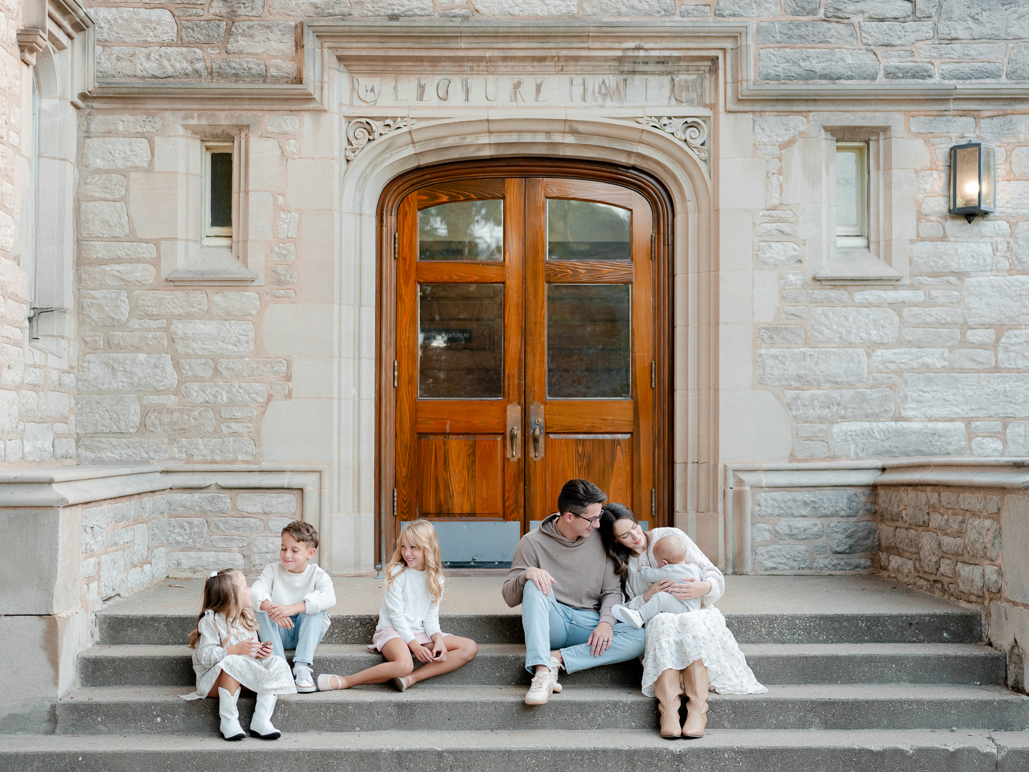The Bedford family enjoying a casual moment sitting on steps in Columbia, Missouri, captured by Love Tree Studios, Columbia Missouri family photographer.