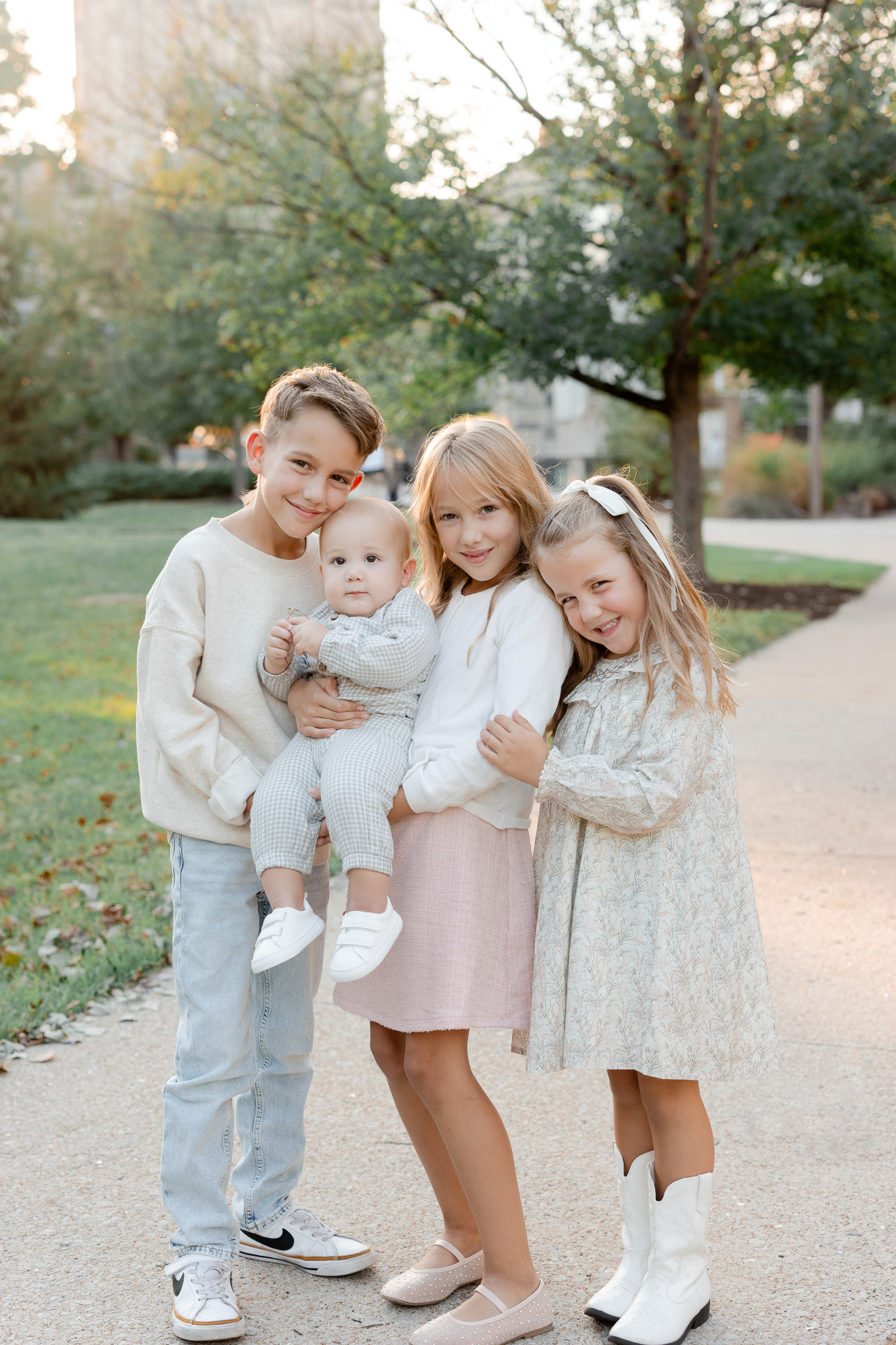 Four Bedford siblings cuddled together, big brother holding the baby, photographed by Love Tree Studios, Columbia Missouri family photographer.