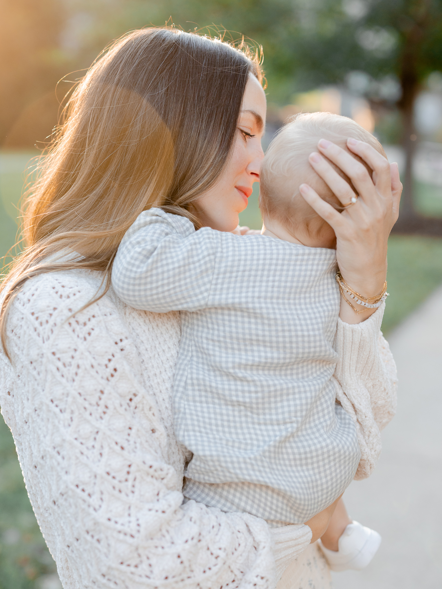 Mother holds her baby close in the glow of sunset during Columbia Missouri family photography session with Love Tree Studios.