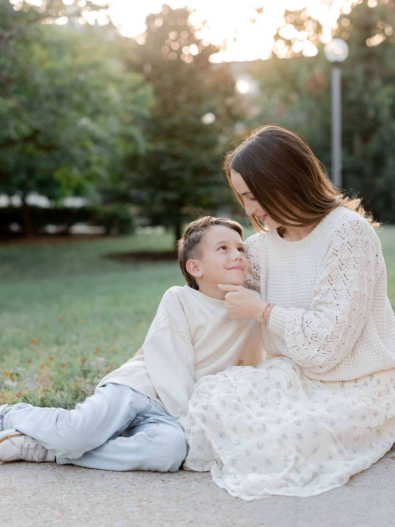 Sweet candid of mom and son smiling at each other on a Columbia path, captured by Columbia Missouri family photographer.