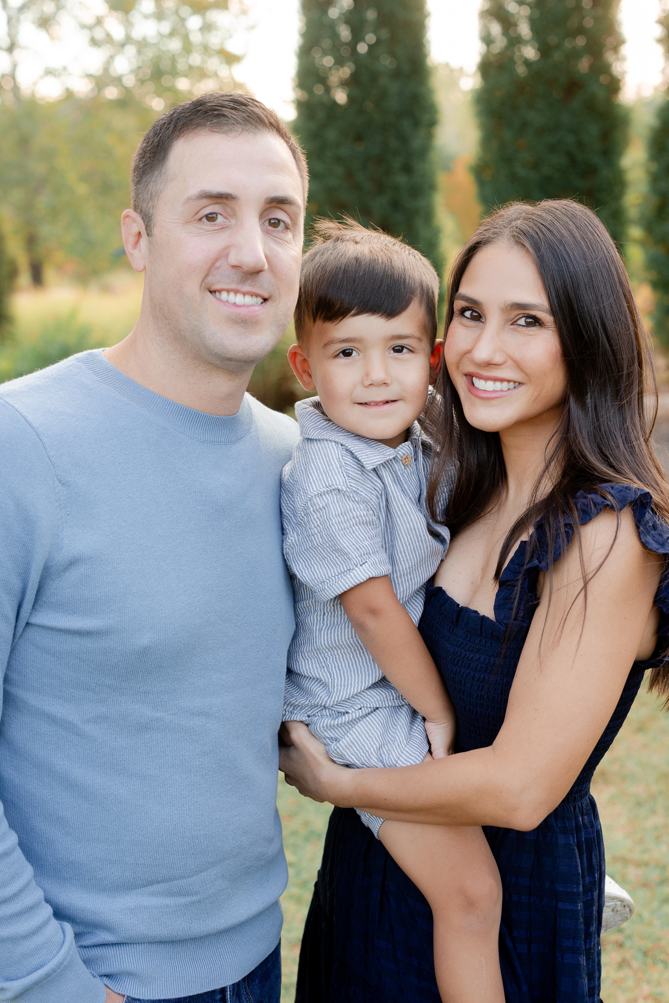 Close-up of mom, dad, and son smiling during their fall family photo session in Columbia Missouri.