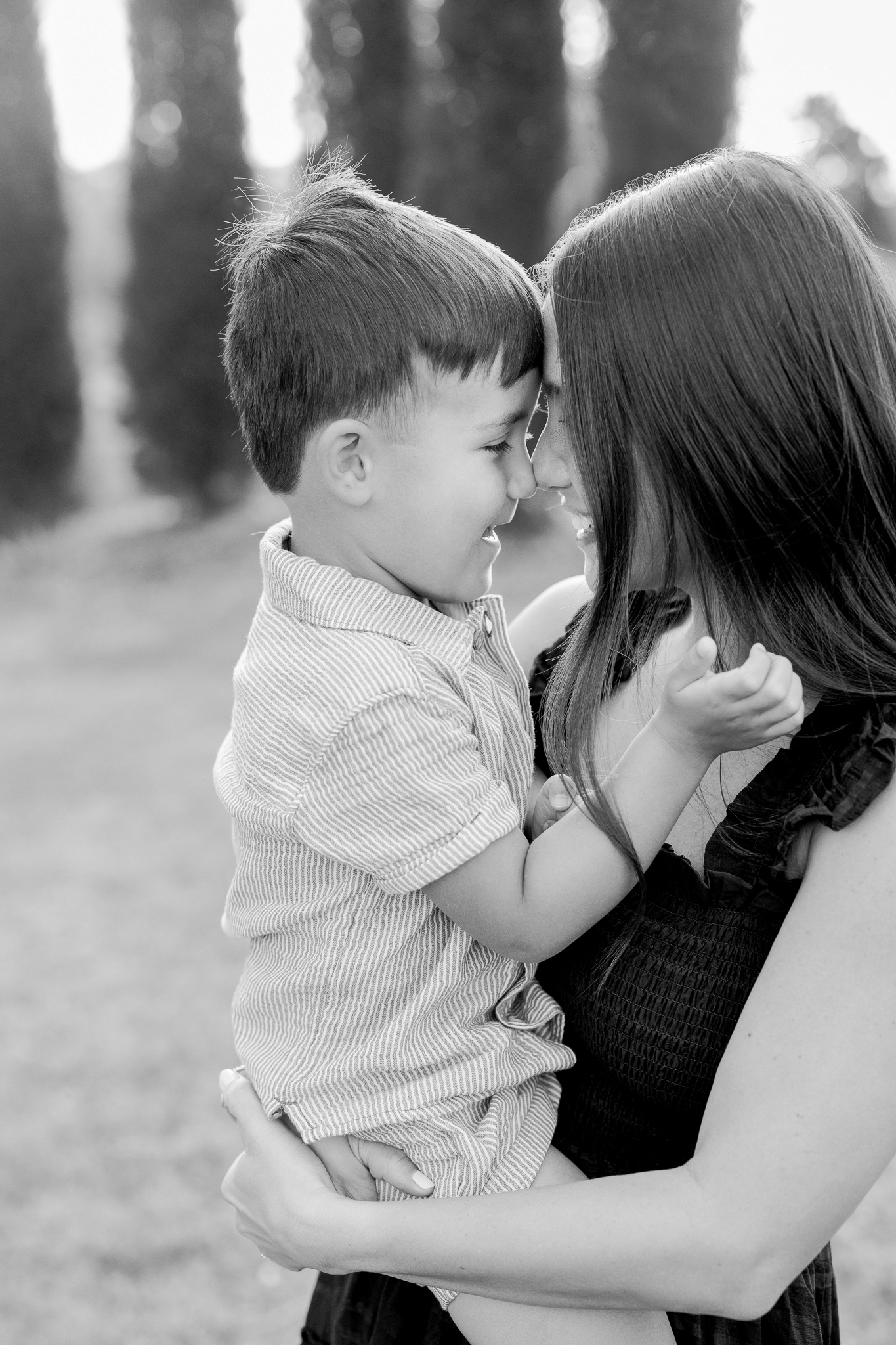 Sweet black-and-white portrait of mom and son touching foreheads during their fall Columbia Missouri family photo session.