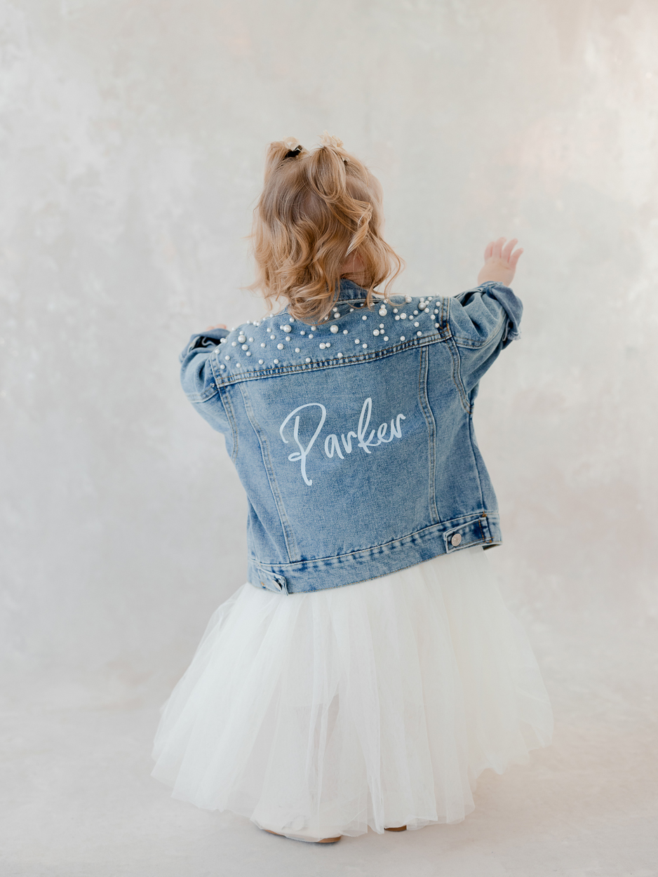 Back view of personalized denim jacket with name Parker during Columbia Missouri studio portrait session.