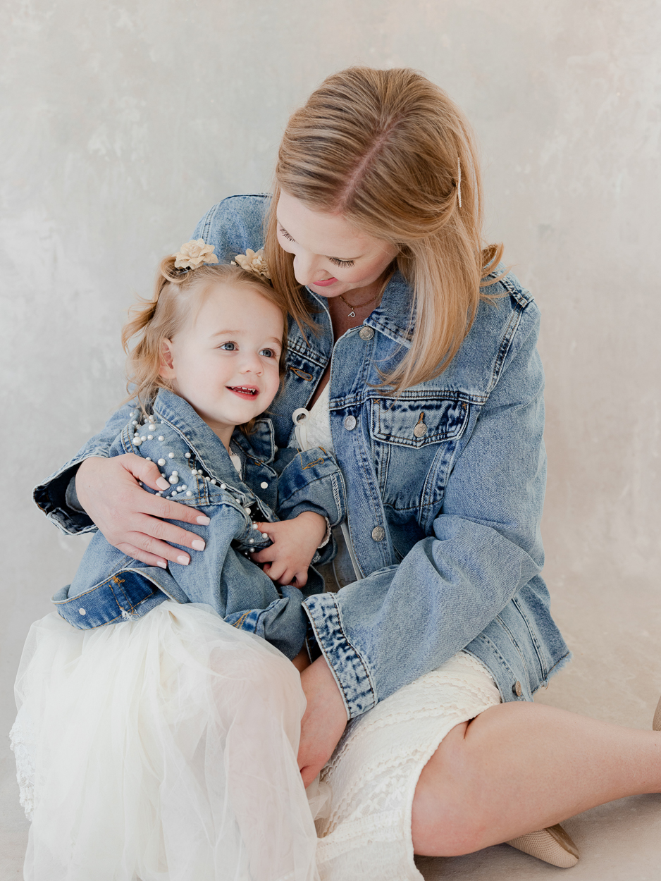 Mother and toddler daughter in matching denim jackets during Columbia Missouri family photography studio session.