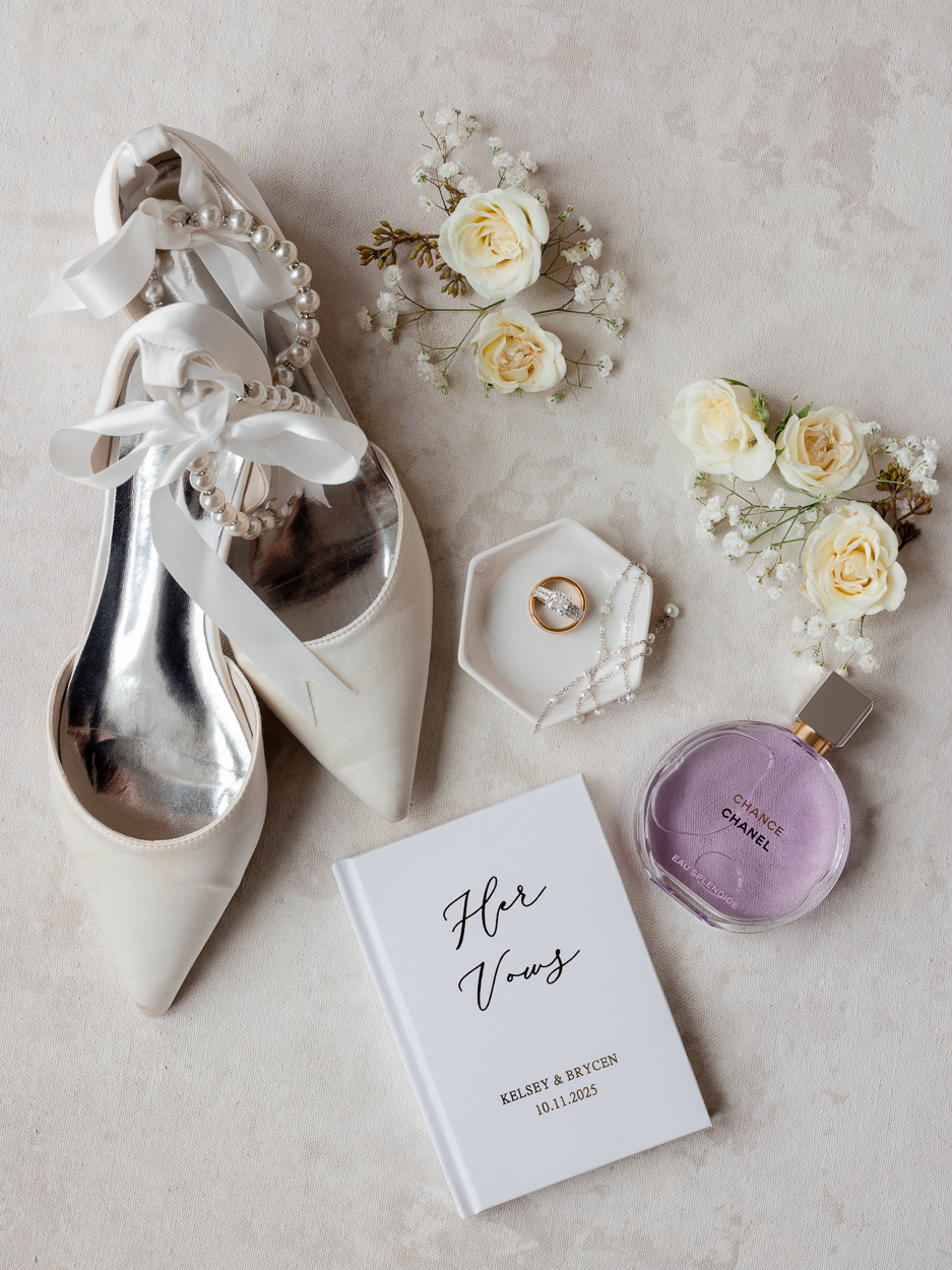 Close-up of engagement ring and wedding bands styled on wedding invitation for a Columbia Missouri church wedding.