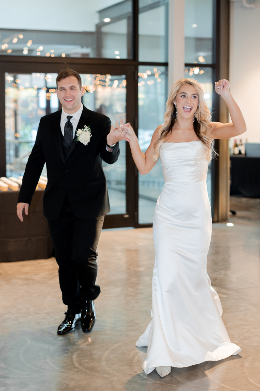 Bride and groom making their grand entrance into the reception at The Atrium on Tenth in Columbia, Missouri.